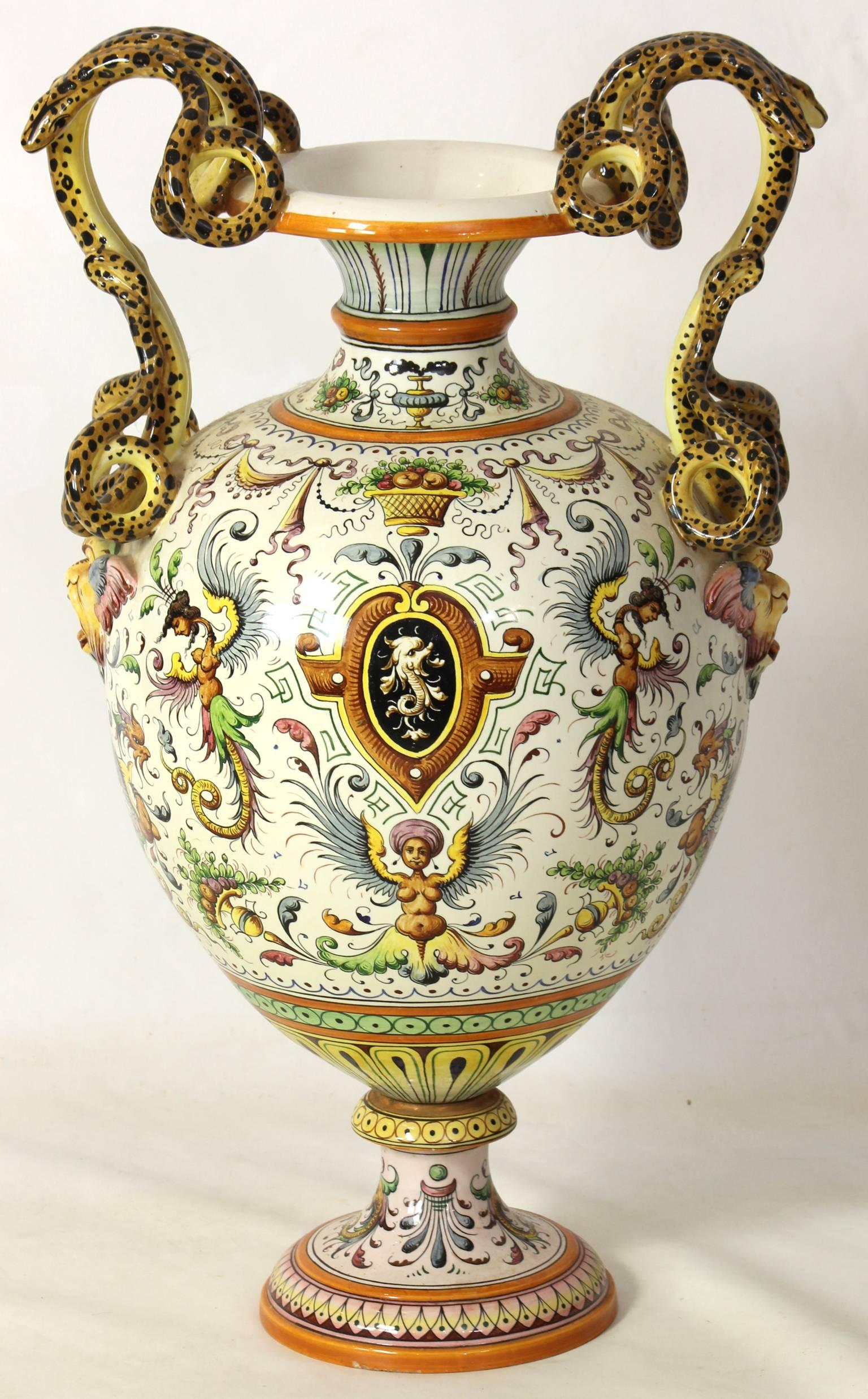 A large early 20th century baluster form Italian Majolica urn with extensive paint decoration and wonderful serpent handles.