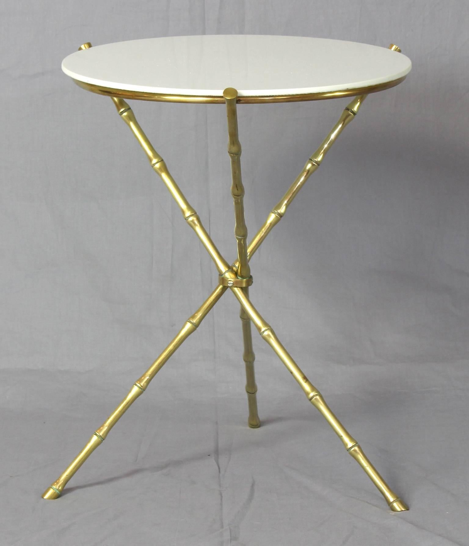 A charming mid-20th century cast brass faux bamboo side table by Maison Bagues inset with white glass top.