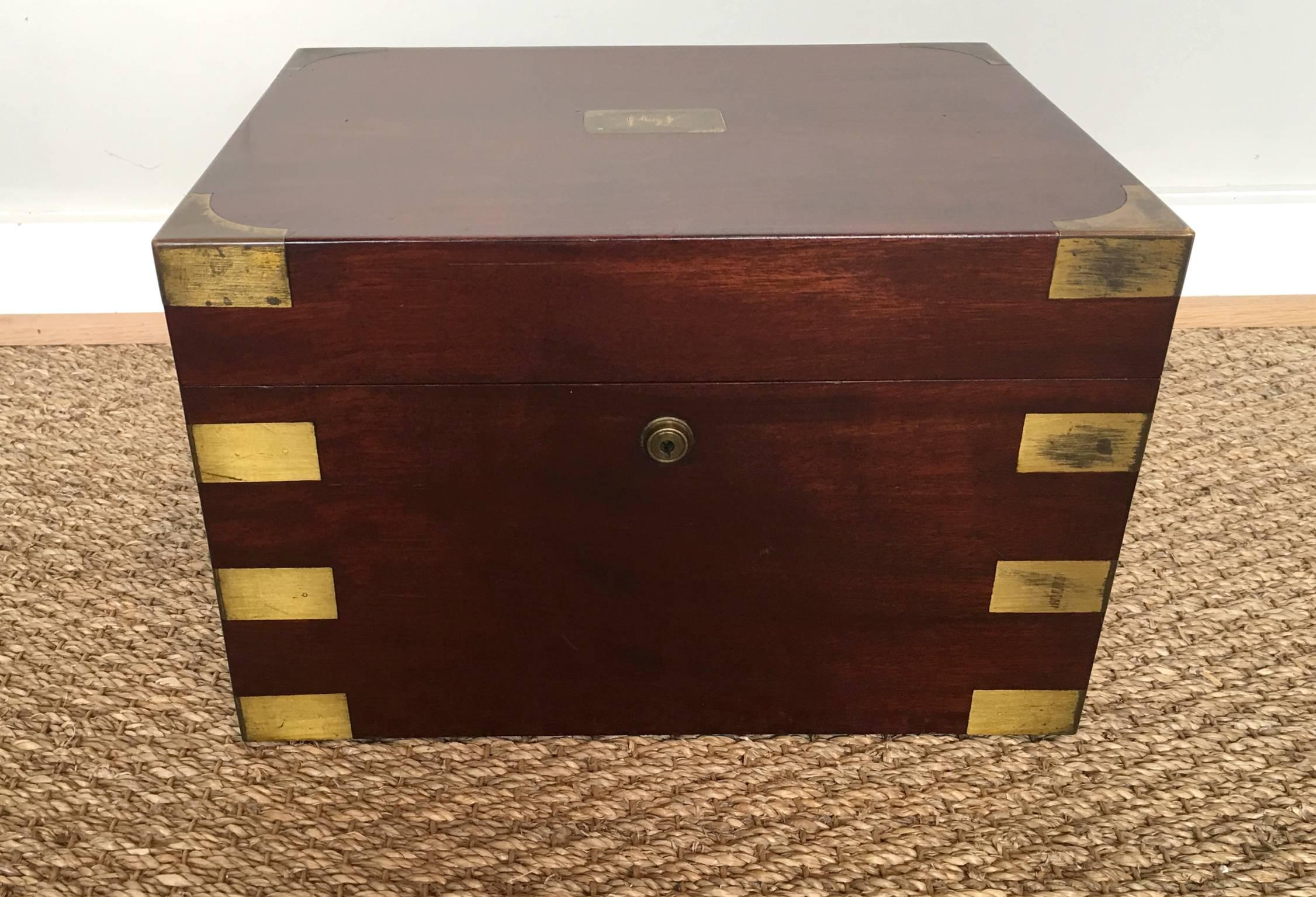 A large English mahogany and brass humidor by Benson & Hedges dating from the early 20th century.