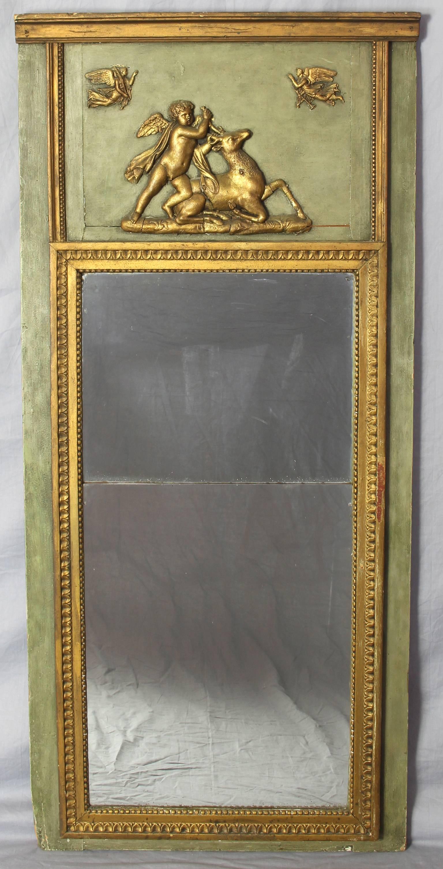 An early 19th century French green paint and gilt decorated mirror with original glass, depicting classical motifs.