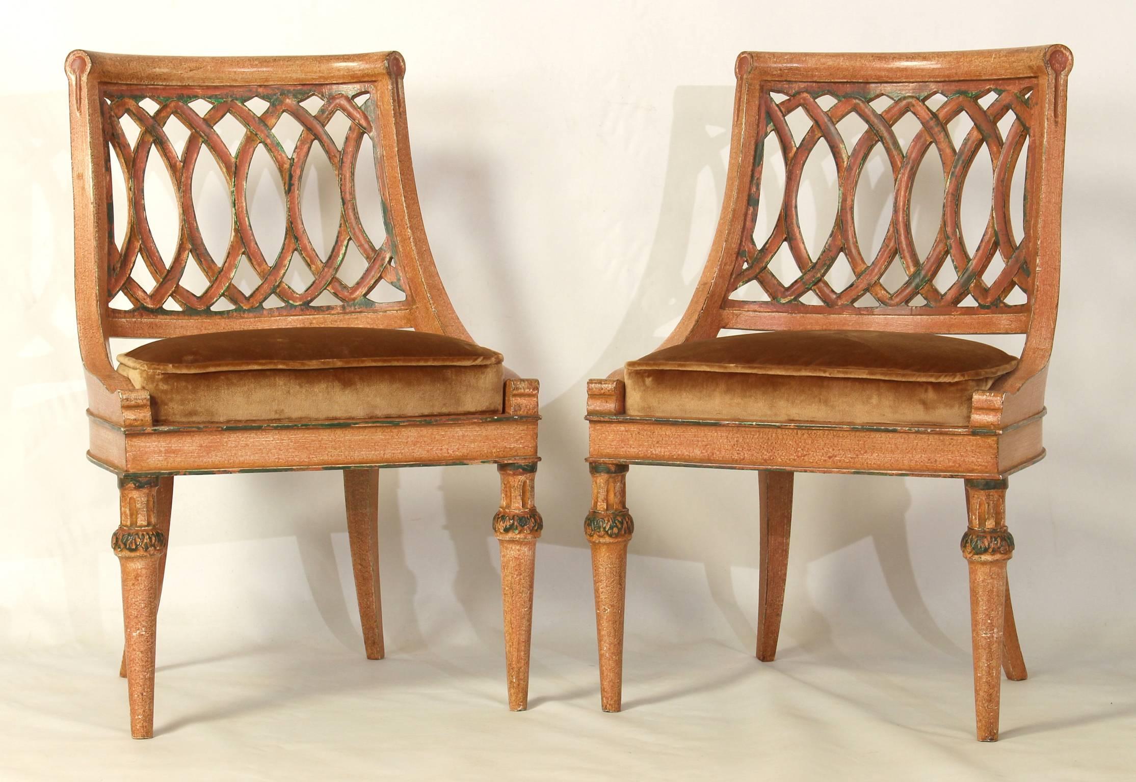 A charming pair of mid-20th century Italian carved and paint decorated slipper chairs with silk velvet upholstered seats.