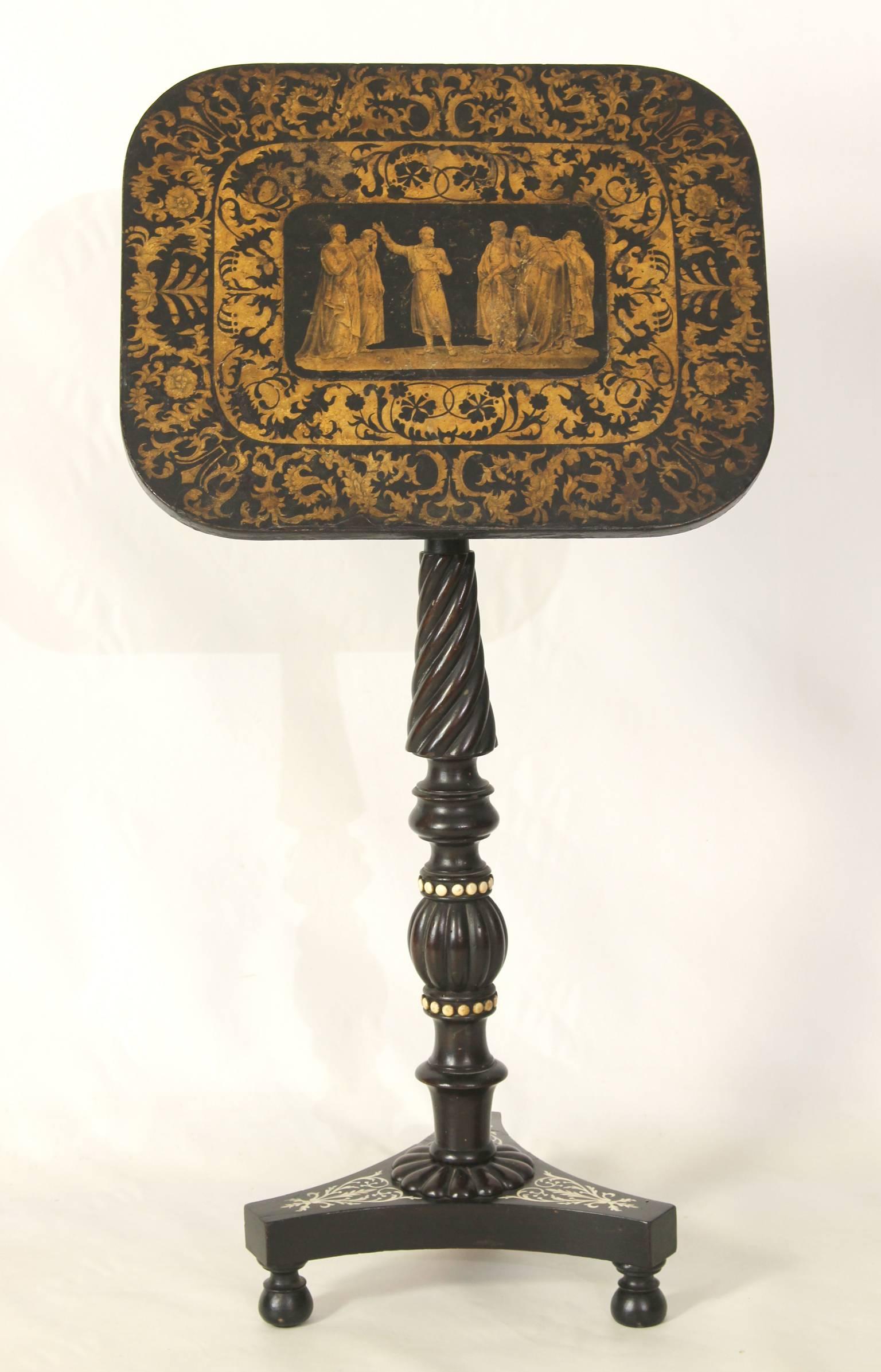 An exceptional English Regency tilt-top penwork table depicting the death of Socrates. The turned and carved base and pedestal are inset and accented with bone decoration.