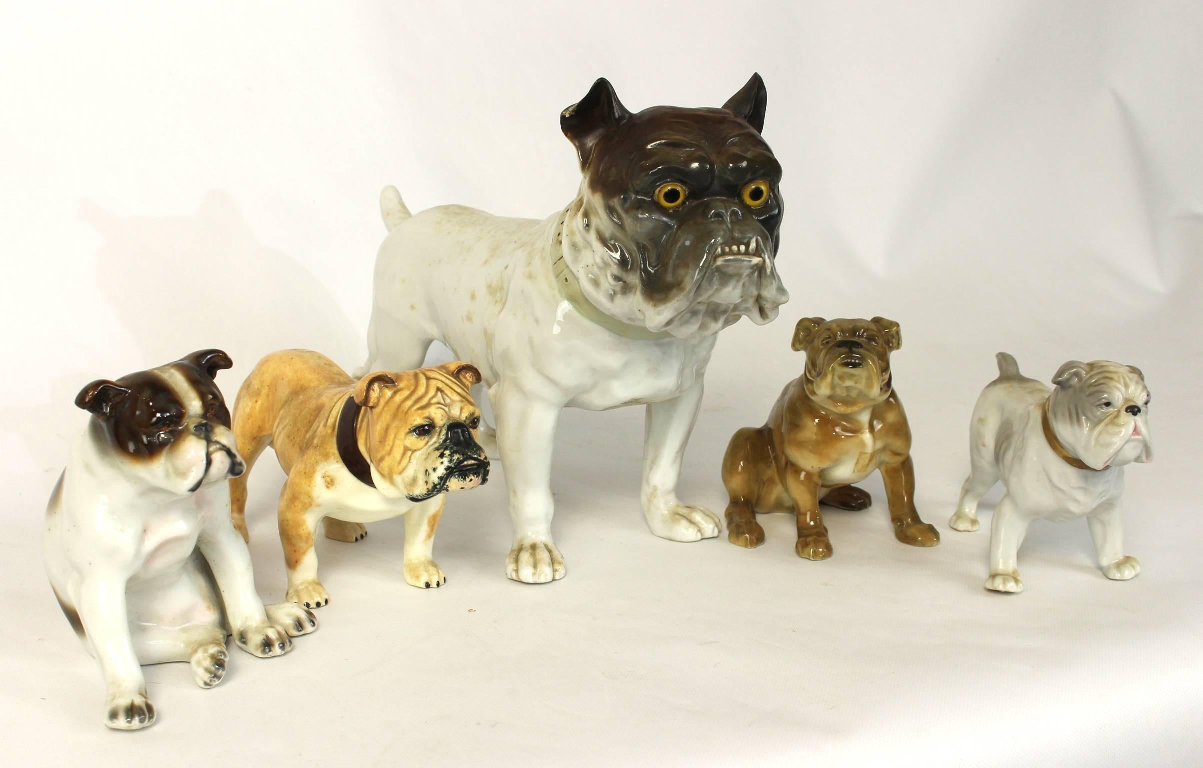 A exceptionally charming collection of five hand-painted porcelain bulldogs in various poses. The assembled collection date from the late 19th through the mid-20th century and were made in various countries throughout Europe and Asia.