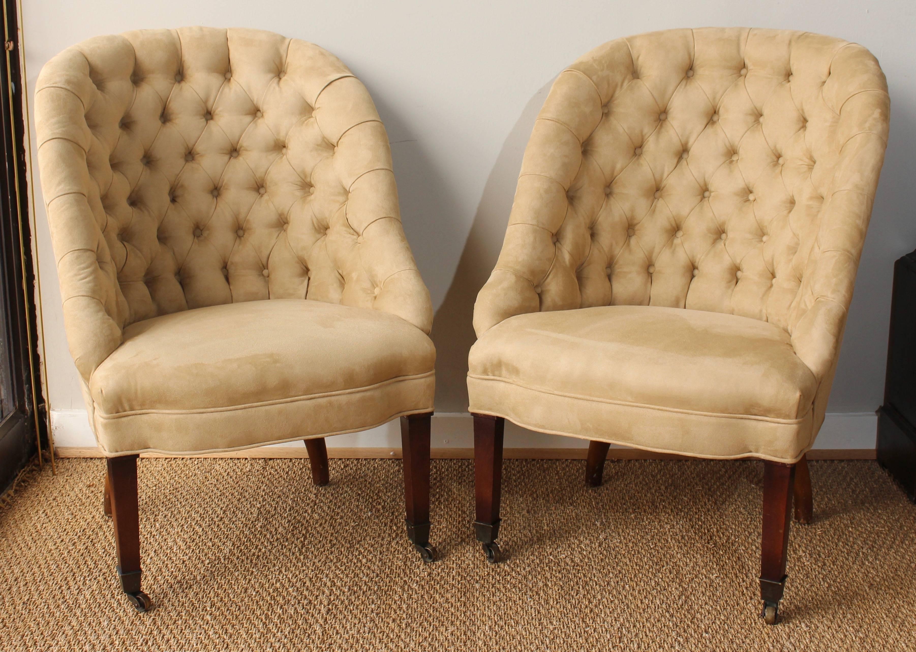 A pair of Regency style buttoned back slipper chairs newly upholstered in buff colored ultrasuede.