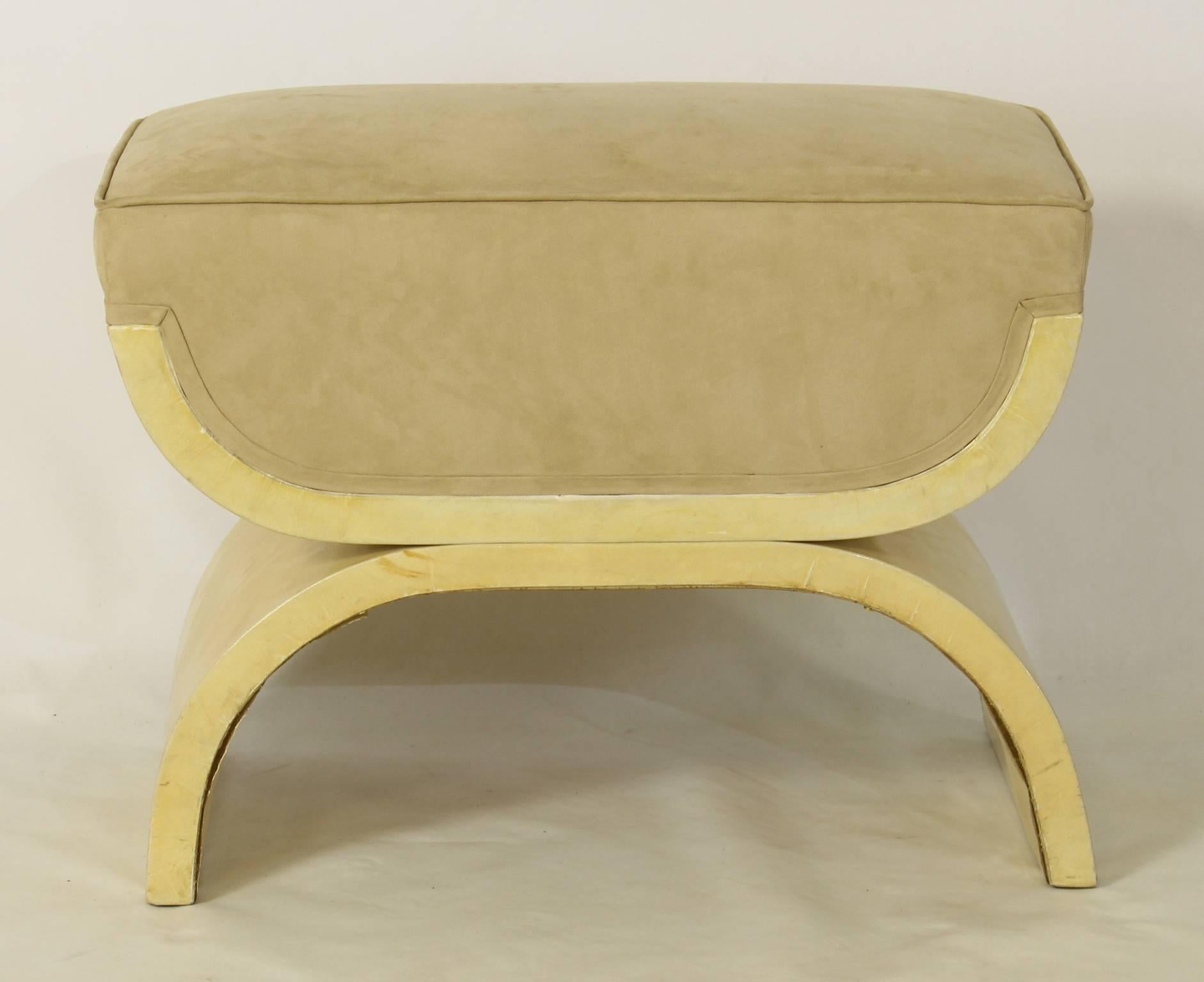 A sleek and elegant Art Deco inspired ottoman or stool covered in a cream colored lacquered goatskin with beige suede seat.