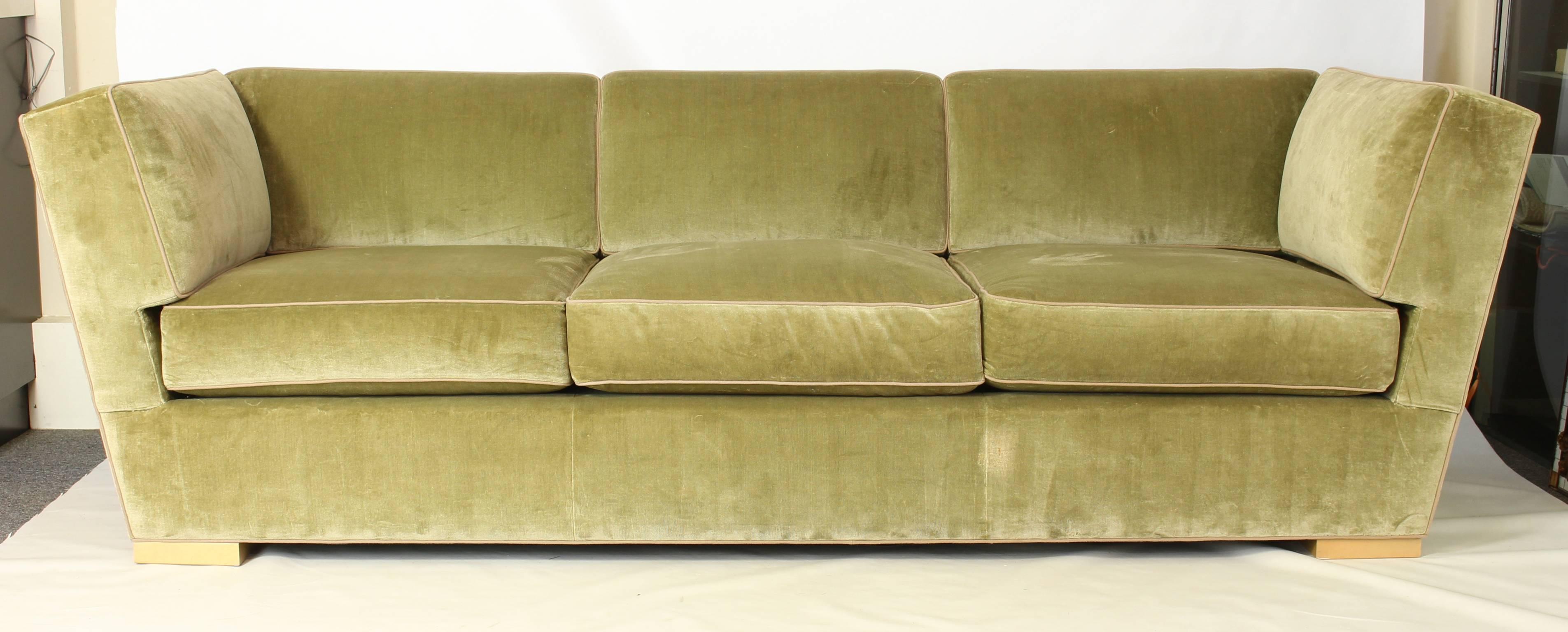 An elegant Art Deco inspired sage green velvet sofa manufactured by Donghia.
