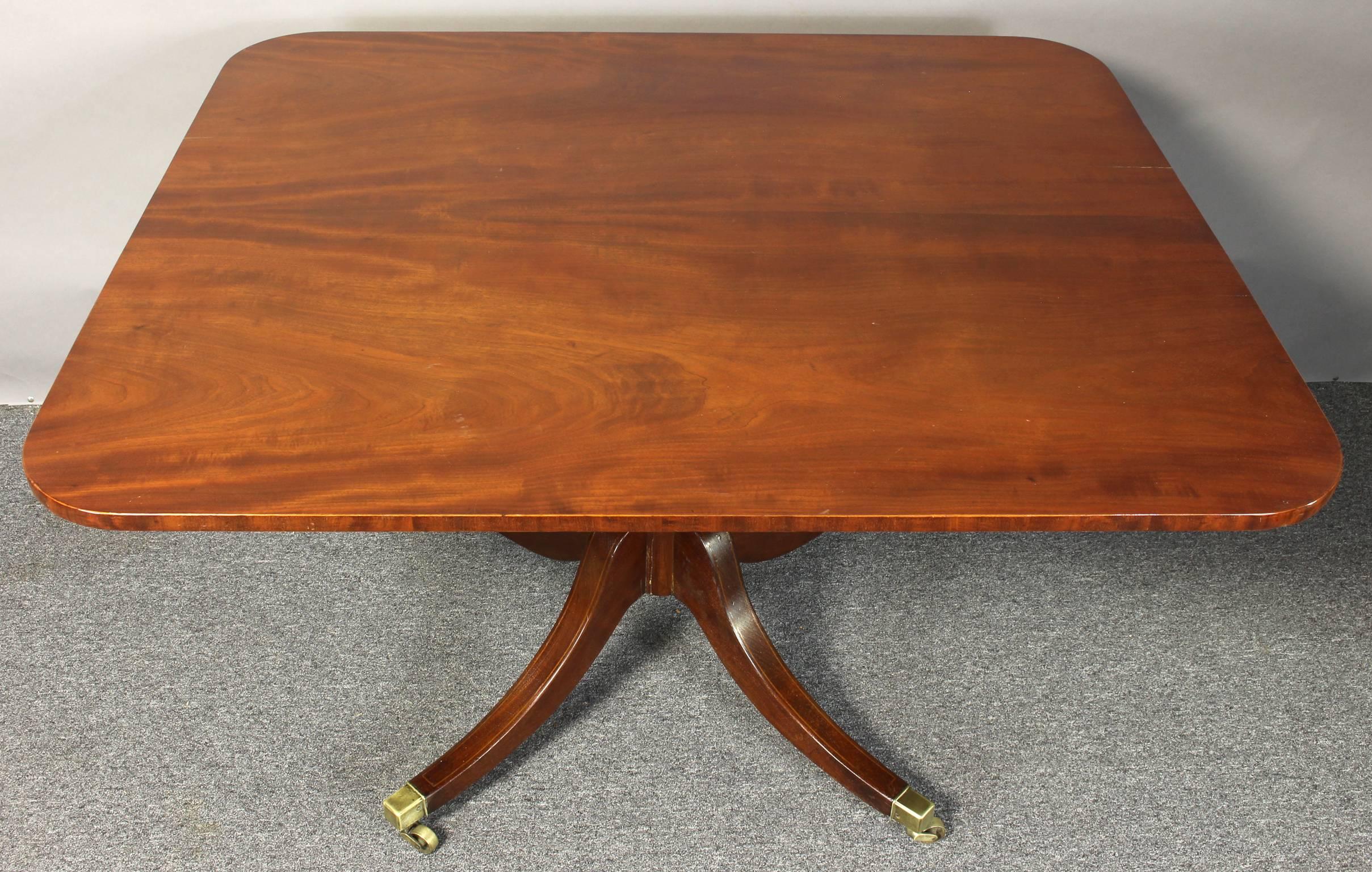 An early 19th Century English mahogany tilt-top breakfast table with rectangular top and turned column on a quadripartite  base. 