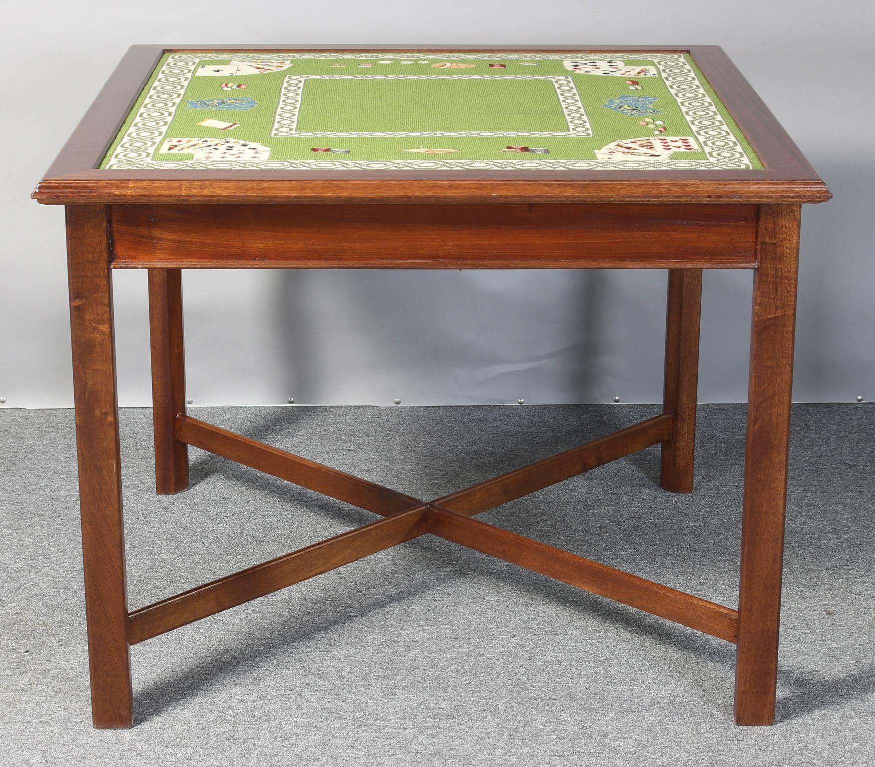 A wonderful custom-made mahogany and needlepoint card or games table. The exquisitely executed vintage needlepoint trompe l'oeil surface depicts a card game on a soft green ground and is in remarkably good condition.