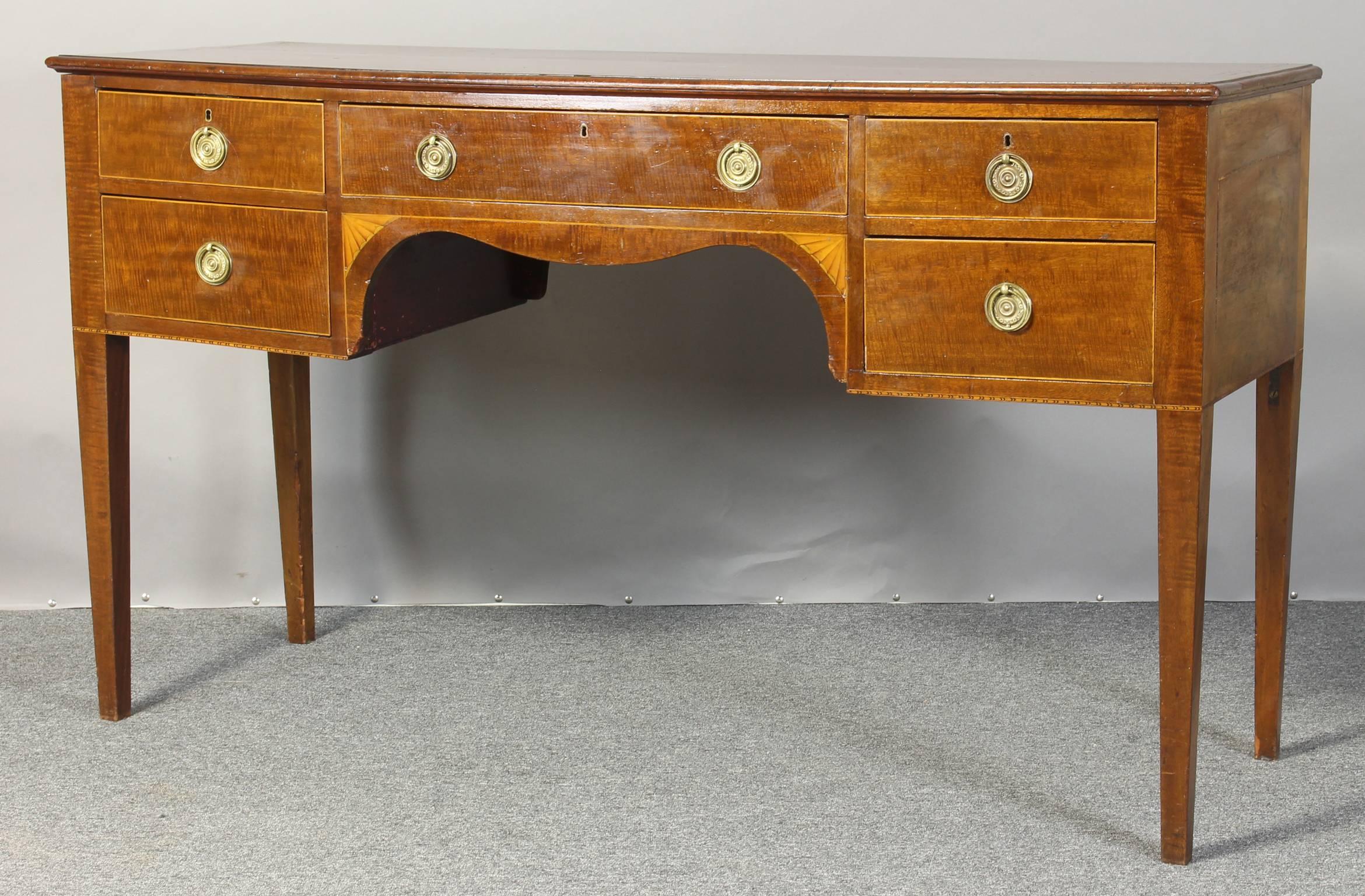 A mid-19th century English mahogany five drawer server or low sideboard accented with satinwood inlay and original brass hardware resting in square tapering legs.