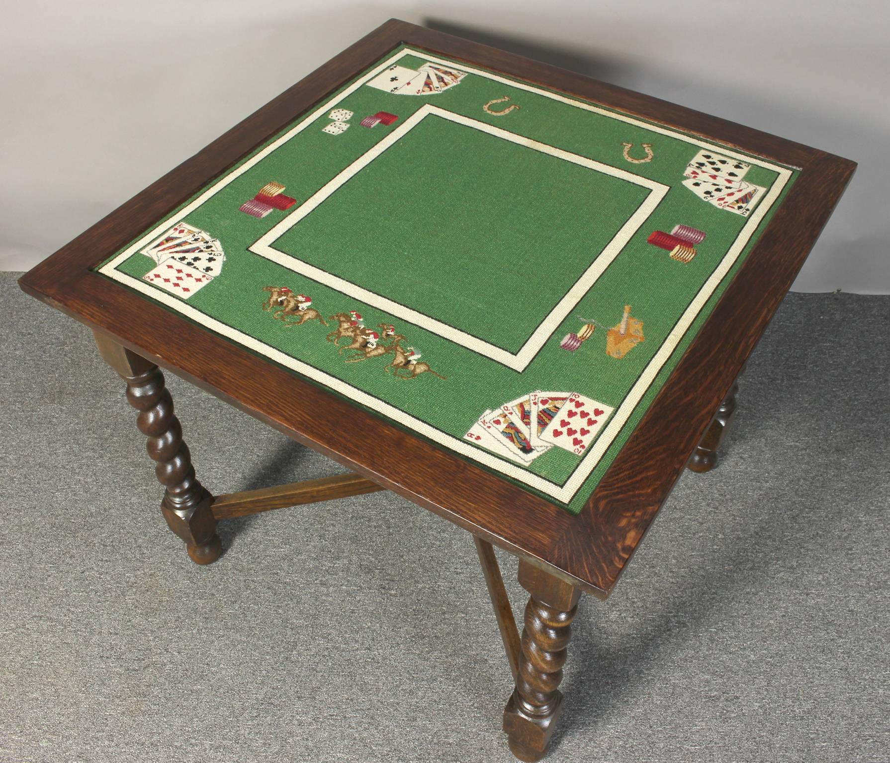 A charming mid-20th century English oak games or card table with wonderful needlepoint playing surface supported on thick barley twist legs.