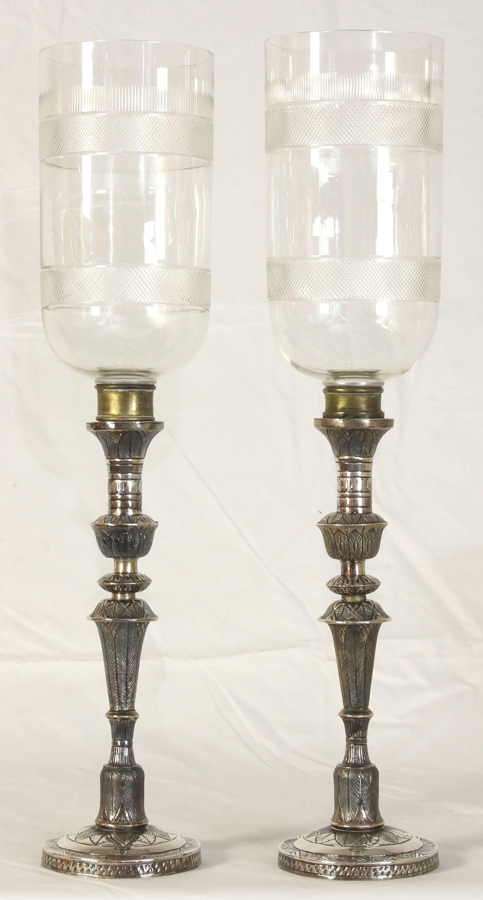 A exceptionally large pair of mid-19th Century Anglo-Indian Silver candlesticks with cut crystal hurricane globes.