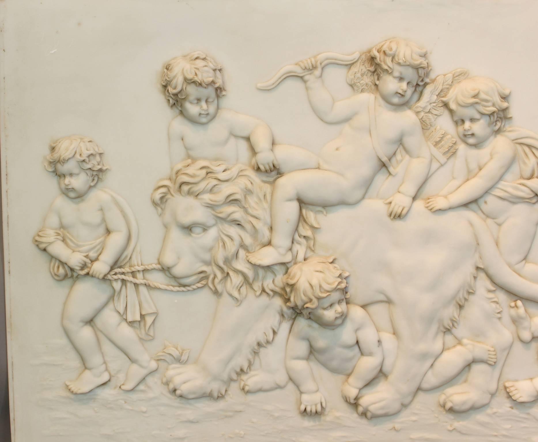 A large and dramatic Parian ware plaque dating from the late 19th century. depicting frolicking cherubs surrounding a tethered lion. Unsigned, possible by the Art Union of London.