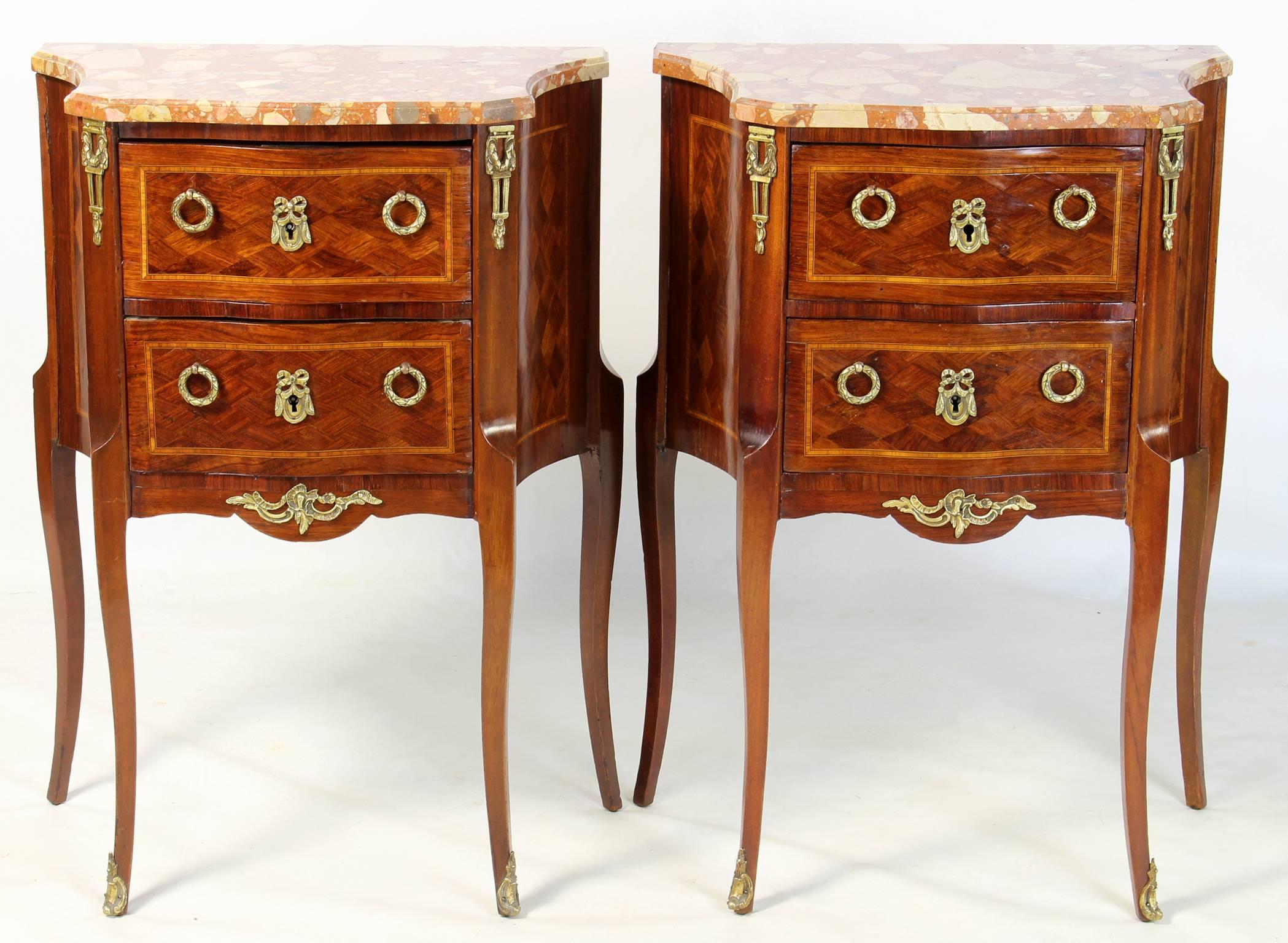 A lovely pair of early 20th C. French inlaid marquetry two-drawer bedside tables with marble tops.