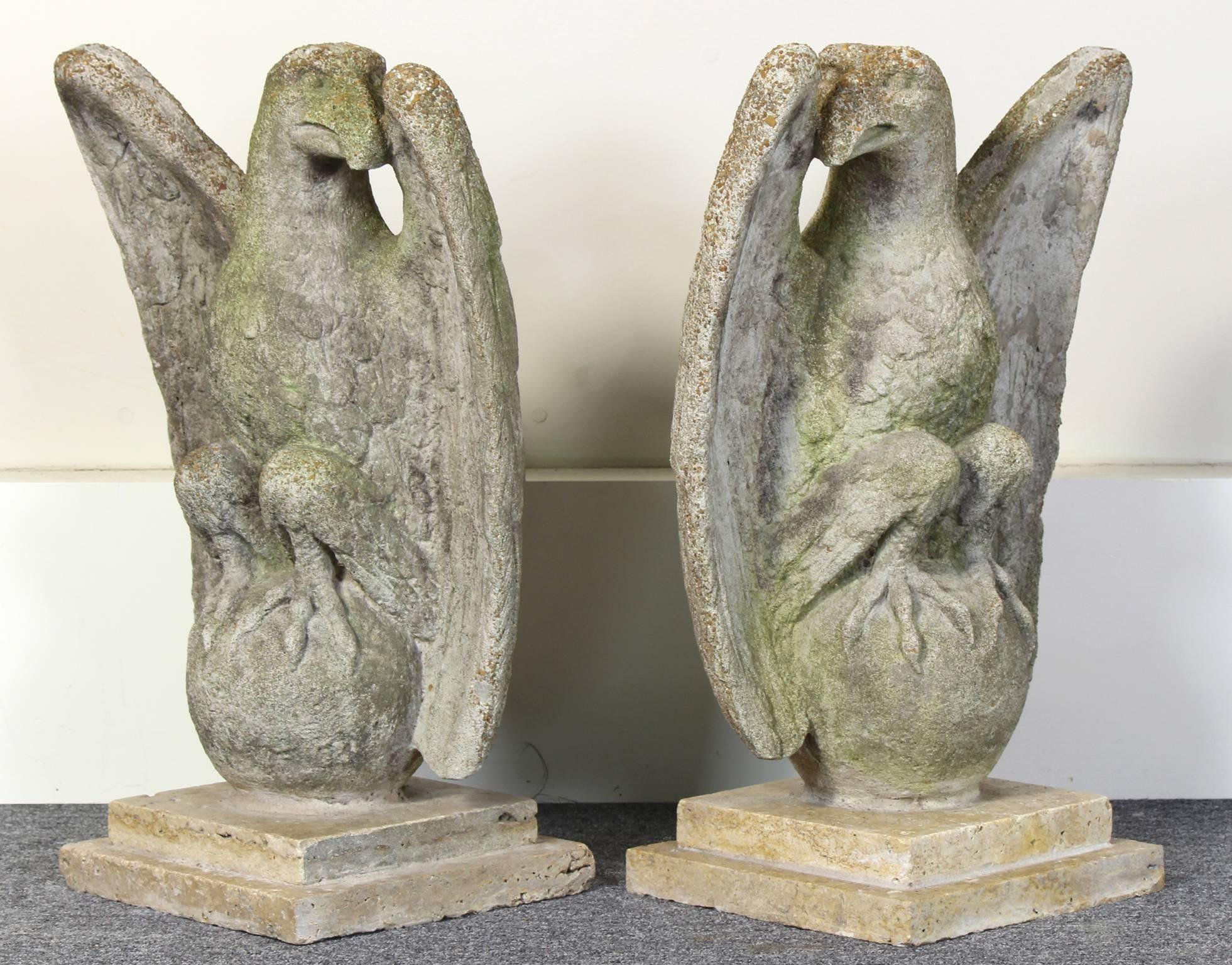 Make an entrance with this stately pair of weathered cast stone eagles in opposing positions perched on orbs resting on marble bases. Perfect for topping gate posts or flanking a front door.  