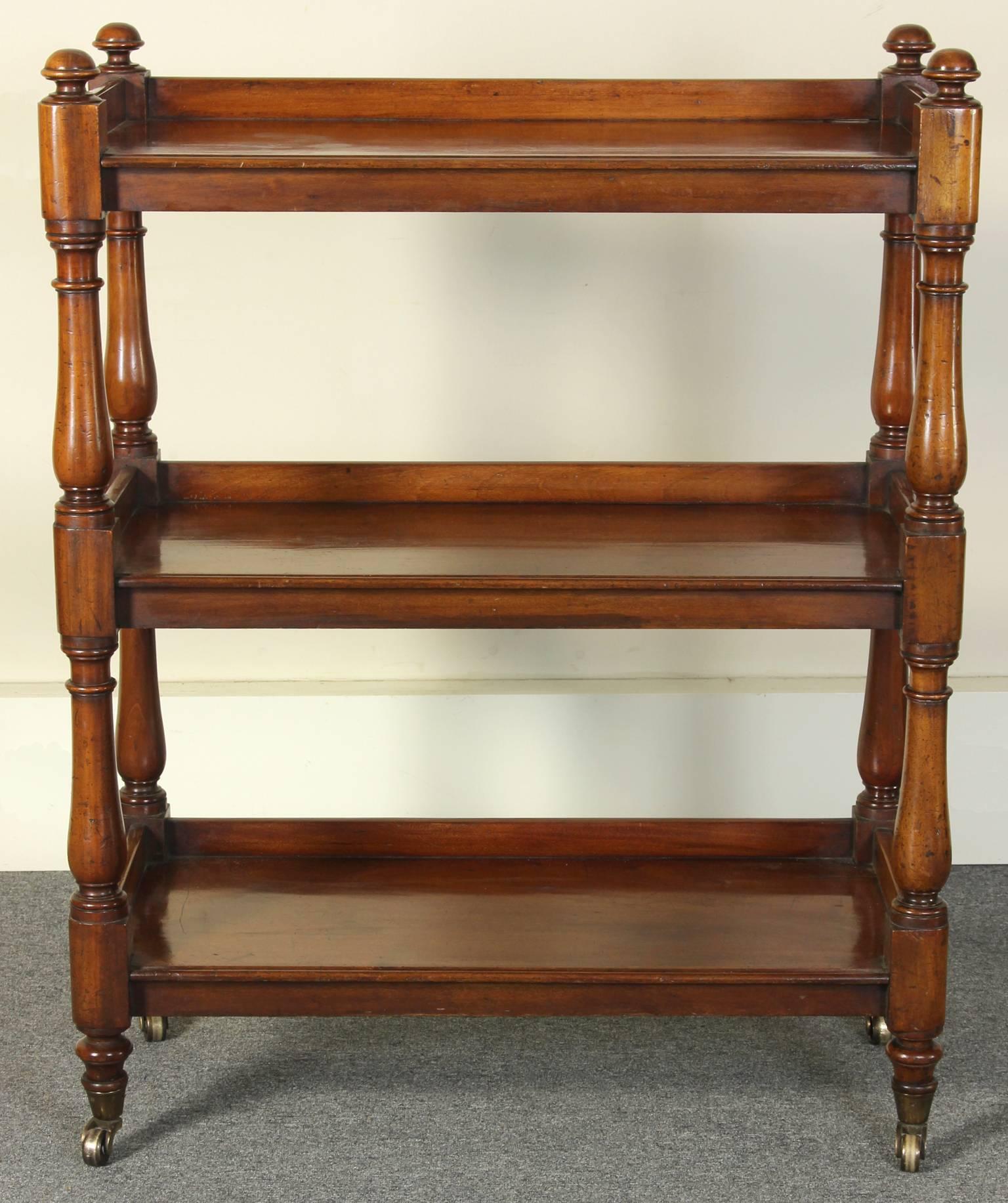 A mid 19th C. English three-shelf server or trolly in beautifully aged mahogany on turned-legs with original brass casters. 