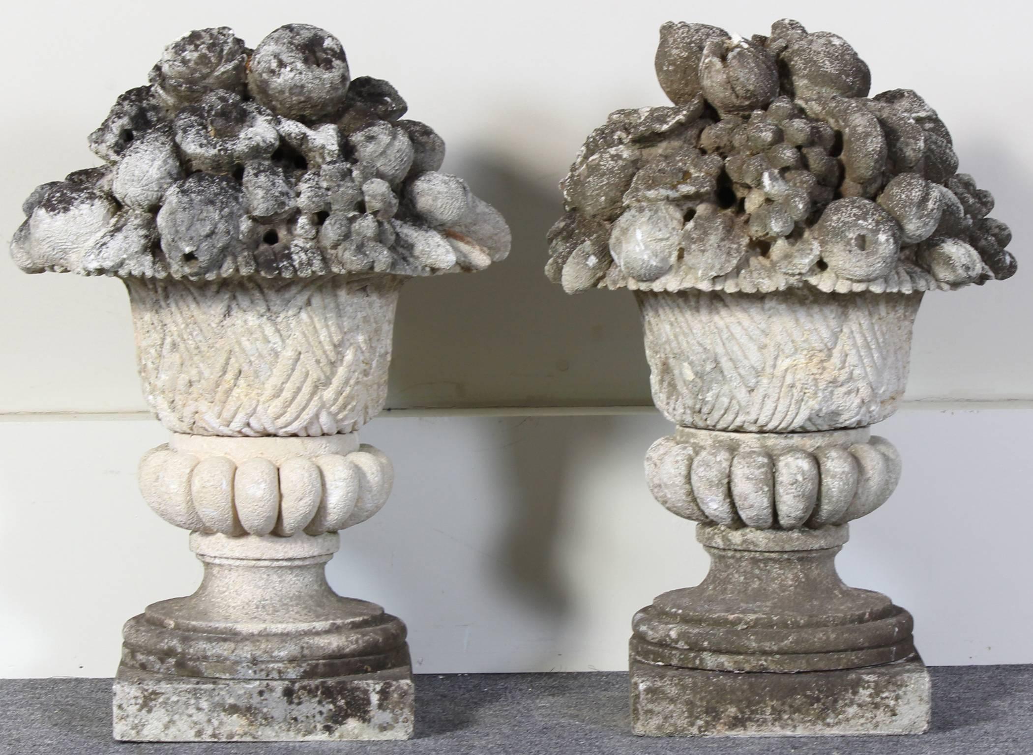 A large pair of vintage cast stone fruit baskets with lovely wear and moss covered surface.