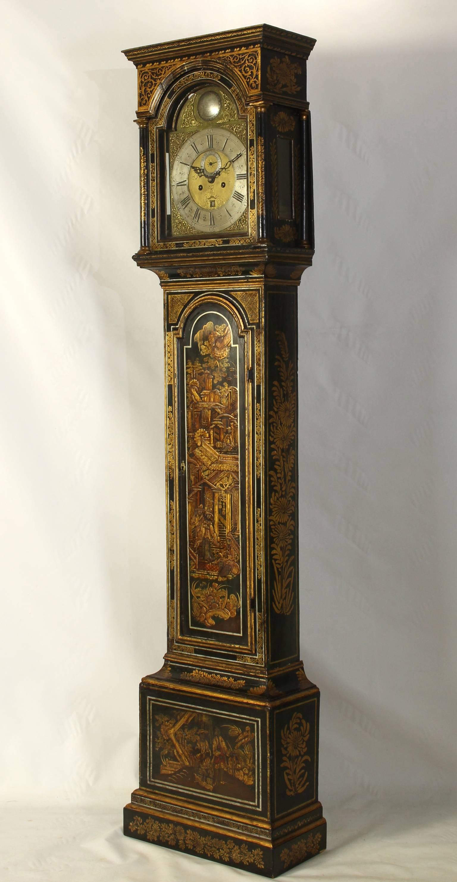 A large and elegant late 18th century English chinoiserie decorated tall case clock in an unusual deep green or blue lacquered background with stylized raised Anglo-Chinese figures in a garden setting by William Harris, London.