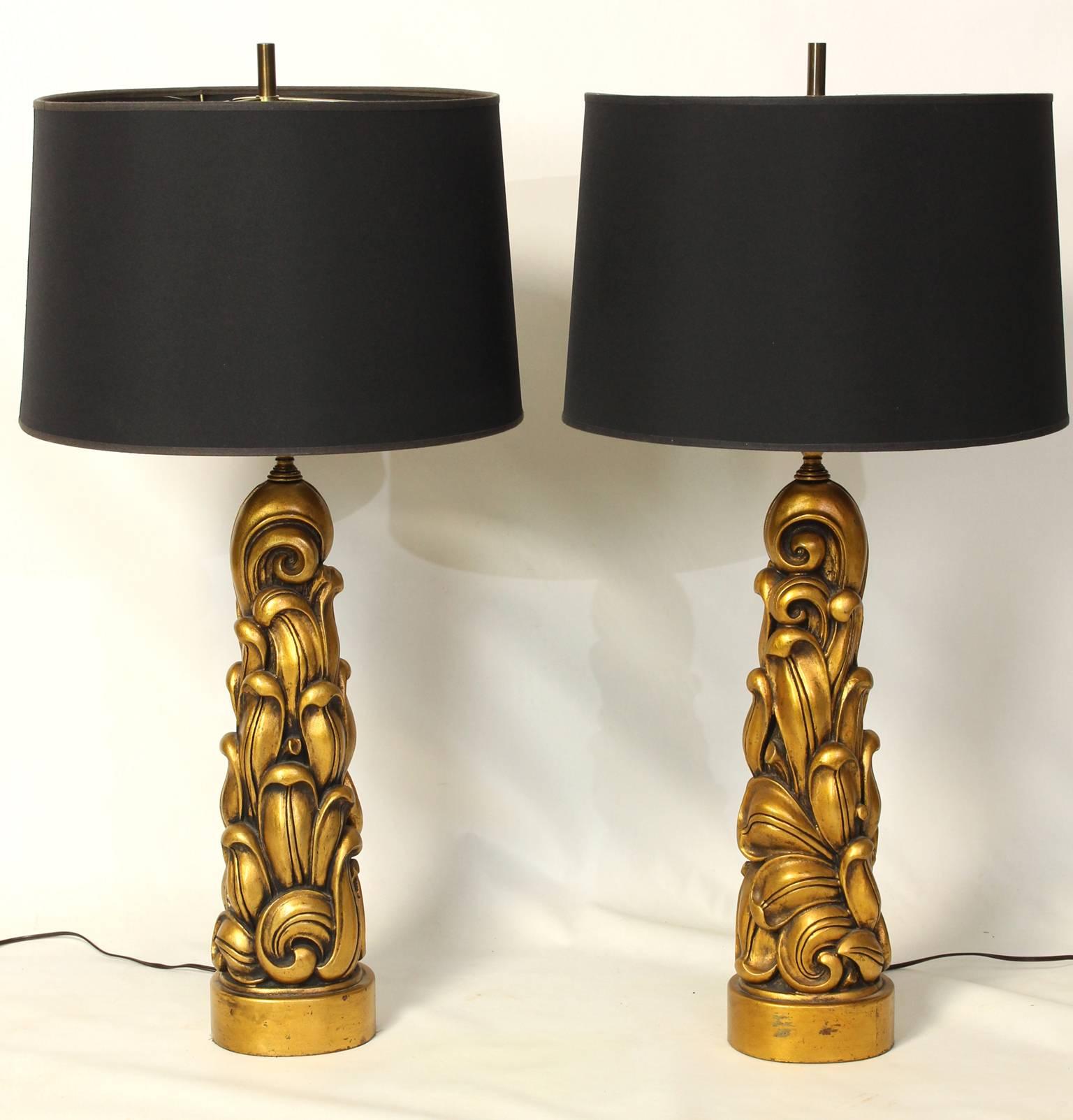 A fantastic pair of large sculptural carved and gilt decorated wood table lamps dating from the 1940's by James Mont. 