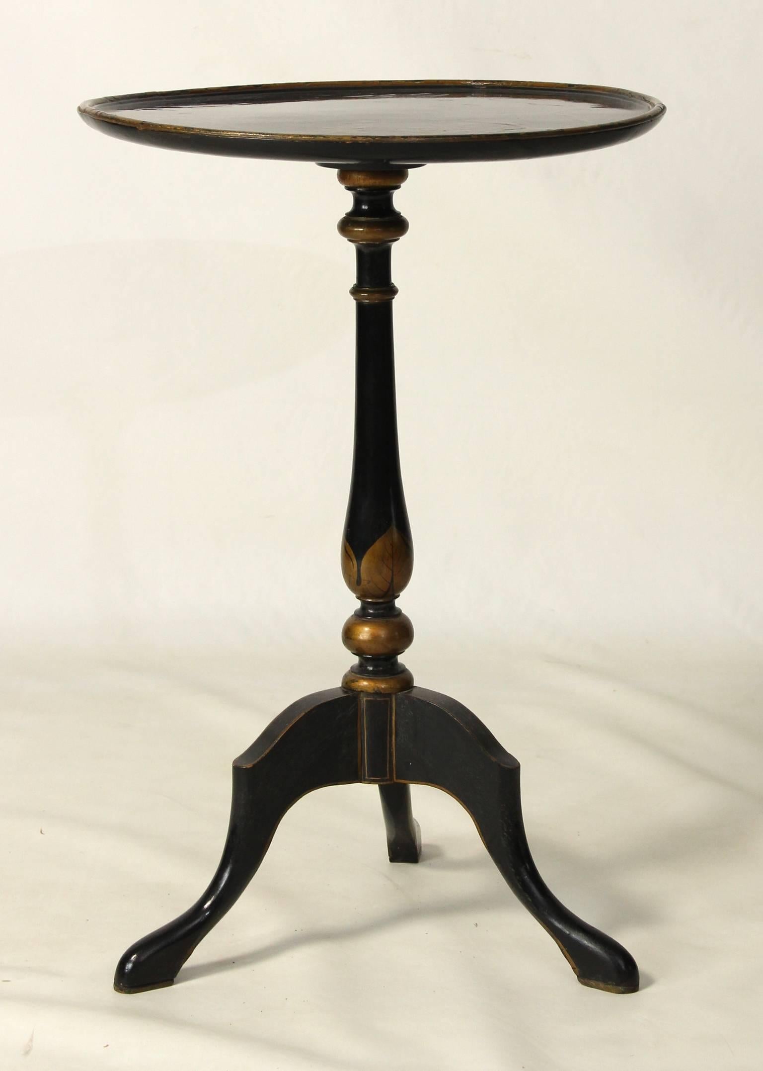 An early 20th century ebonized and chinoiserie decorated candle stand table. 