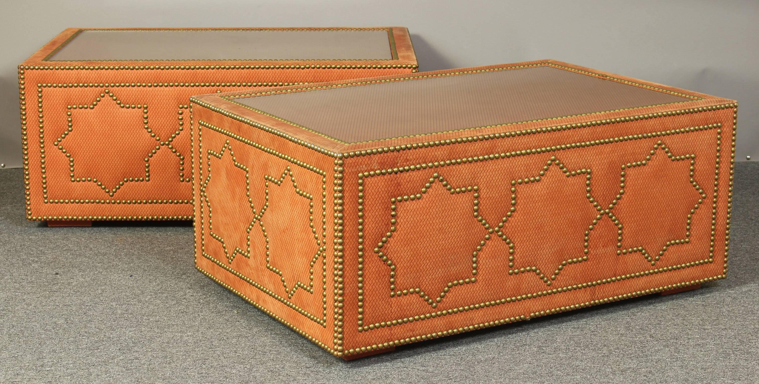 Fantastic custom-made persimmon colored suede upholstered cocktail table with gold toned tack accents, inset with glass tops.