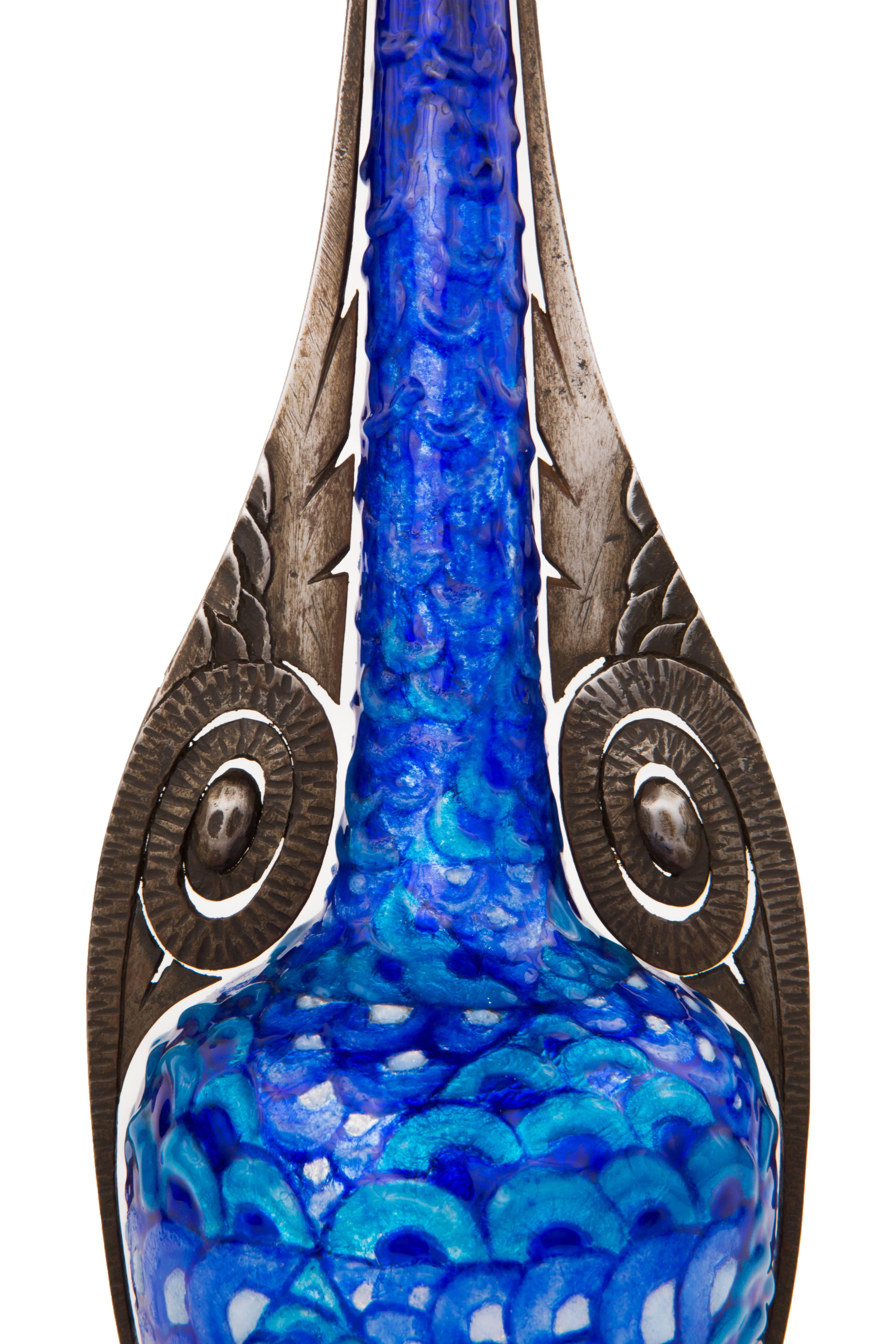 An extremely rare French Art Deco enameled laid on copper and wrought iron decorated vase by, Camille Fauré. The vase is decorated with an enameled geometric design in colors of blue, black, and white further set into a decorated hand forged wrought