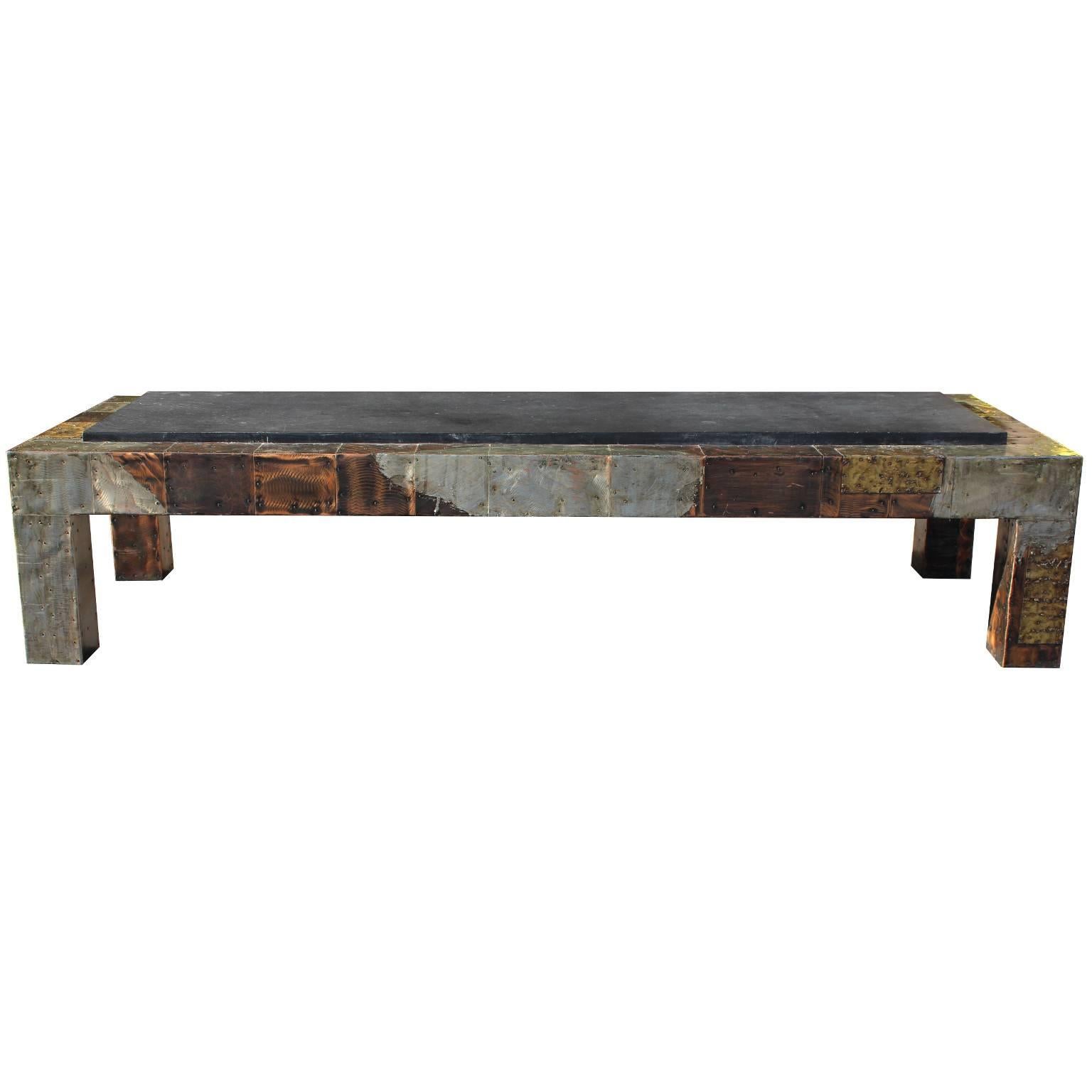 This vintage coffee table by designer Paul Evans, produced circa 1970s, comes with a slate top, over a very lengthy, Brutalist style frame with mixed-metal patchwork. This piece is in good condition, with age appropriate wear.

9708