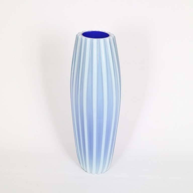 A spectacular sample of Murano glass, produced by Barovier & Toso, circa 1940s, with vibrant cobalt interior, encased in light blue ribbed opaline. The vase is in very good vintage condition, consistent with age and use.