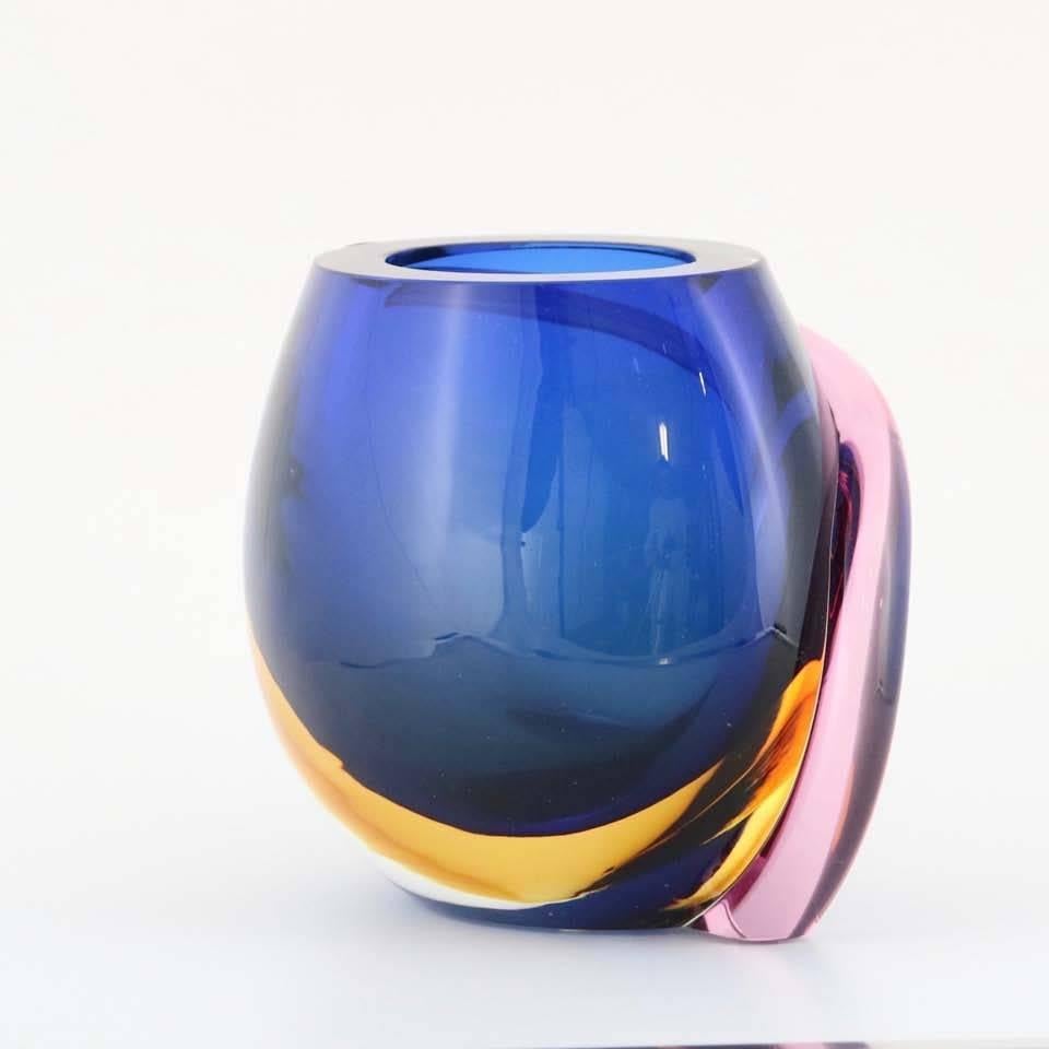 This high quality Murano glass vase, produced in Italy circa 1990s by Formia, was created in the Sommerso style and crafted into a uniquely rounded organic form, displaying a brilliant mix of colors; heavy in weight. Very good condition, consistent