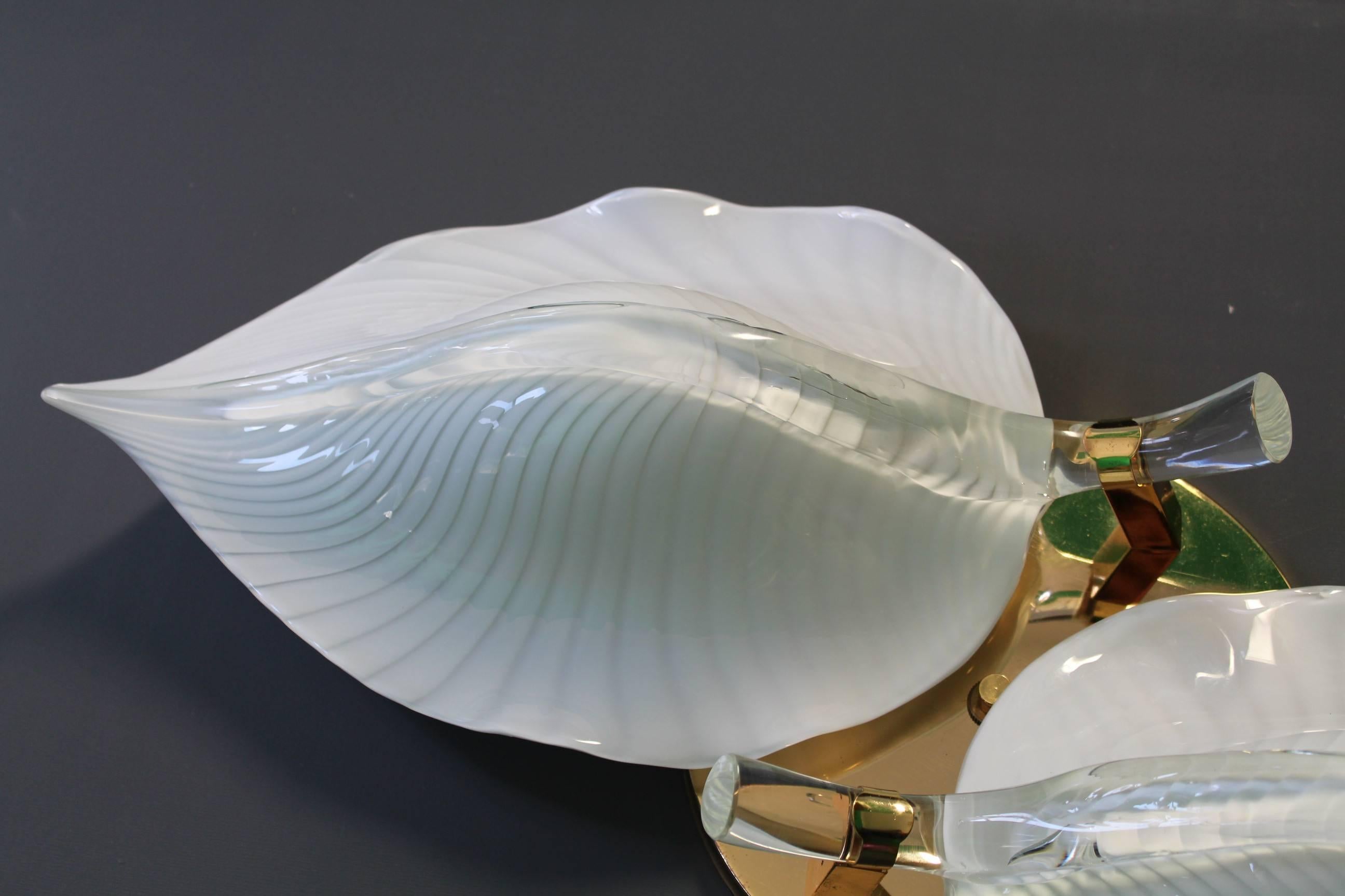 A vintage 1970s Flush Mount, with two leaf form shades in white striped Murano glass, supported by a round back plate in brass. Each leaf measures 19
