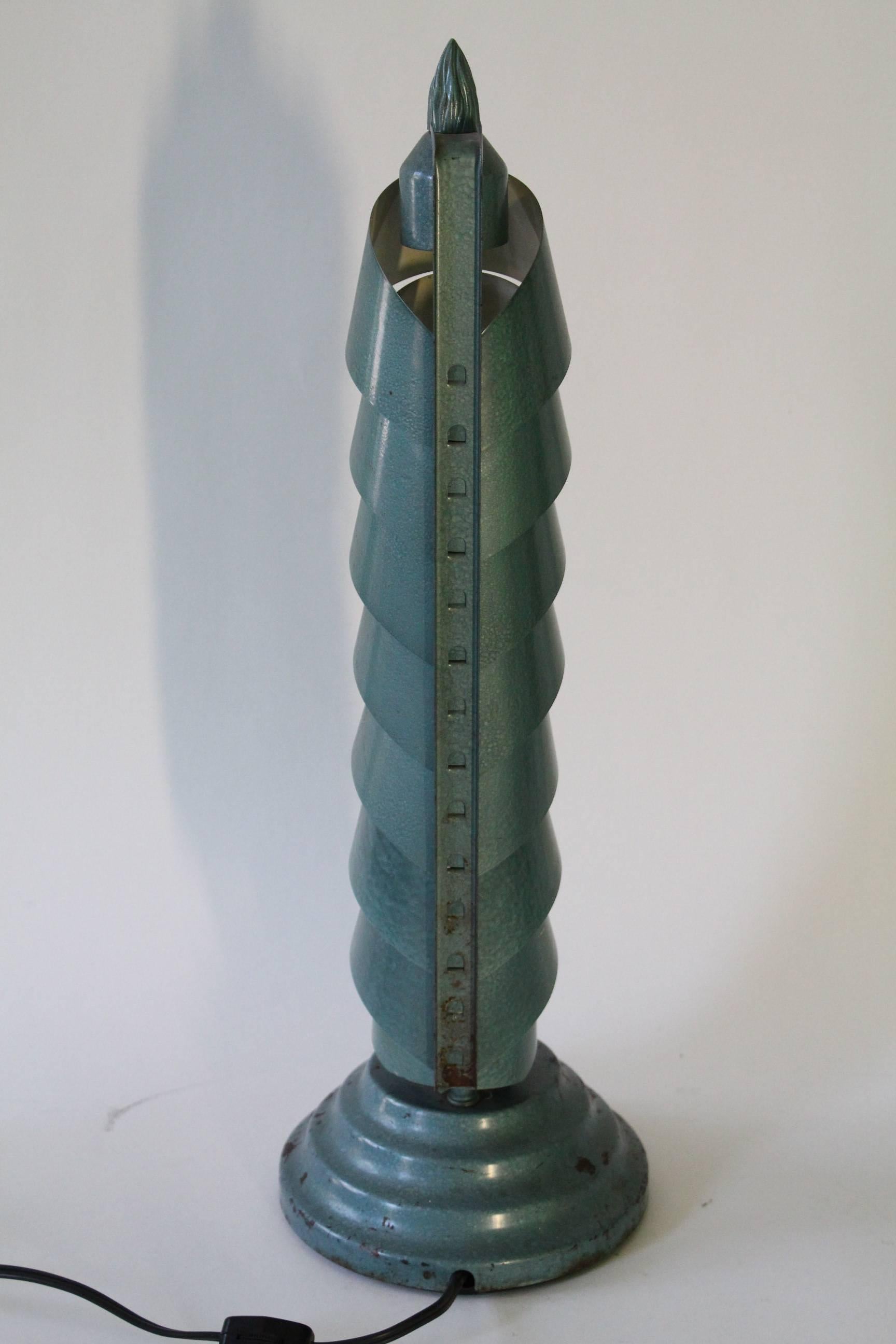 A pair of unique Art Deco style table lamps in green aluminum, produced, circa 1940s, with streamlined layered shades, on round stepped bases; inactive on/off switches to bases, rewired with new switches to cords. Despite age appropriate wear,