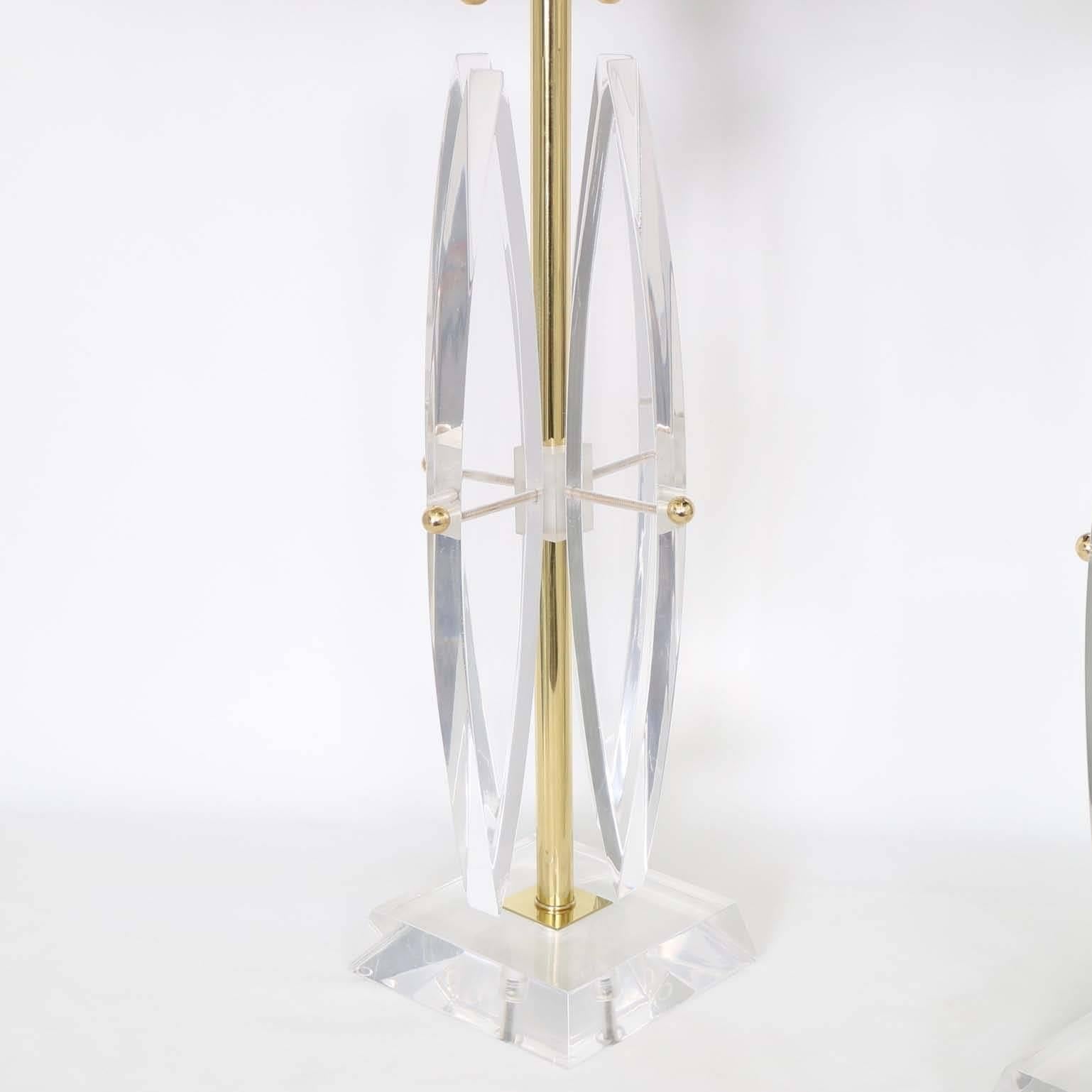 A pair of spectacular Lucite Astrolite lamps, produced circa 1950s by Ritts Company, with brass accents. The noted height is to the finial, the height to the top of the Lucite body measures 22″. These lamps remain in excellent vintage condition,