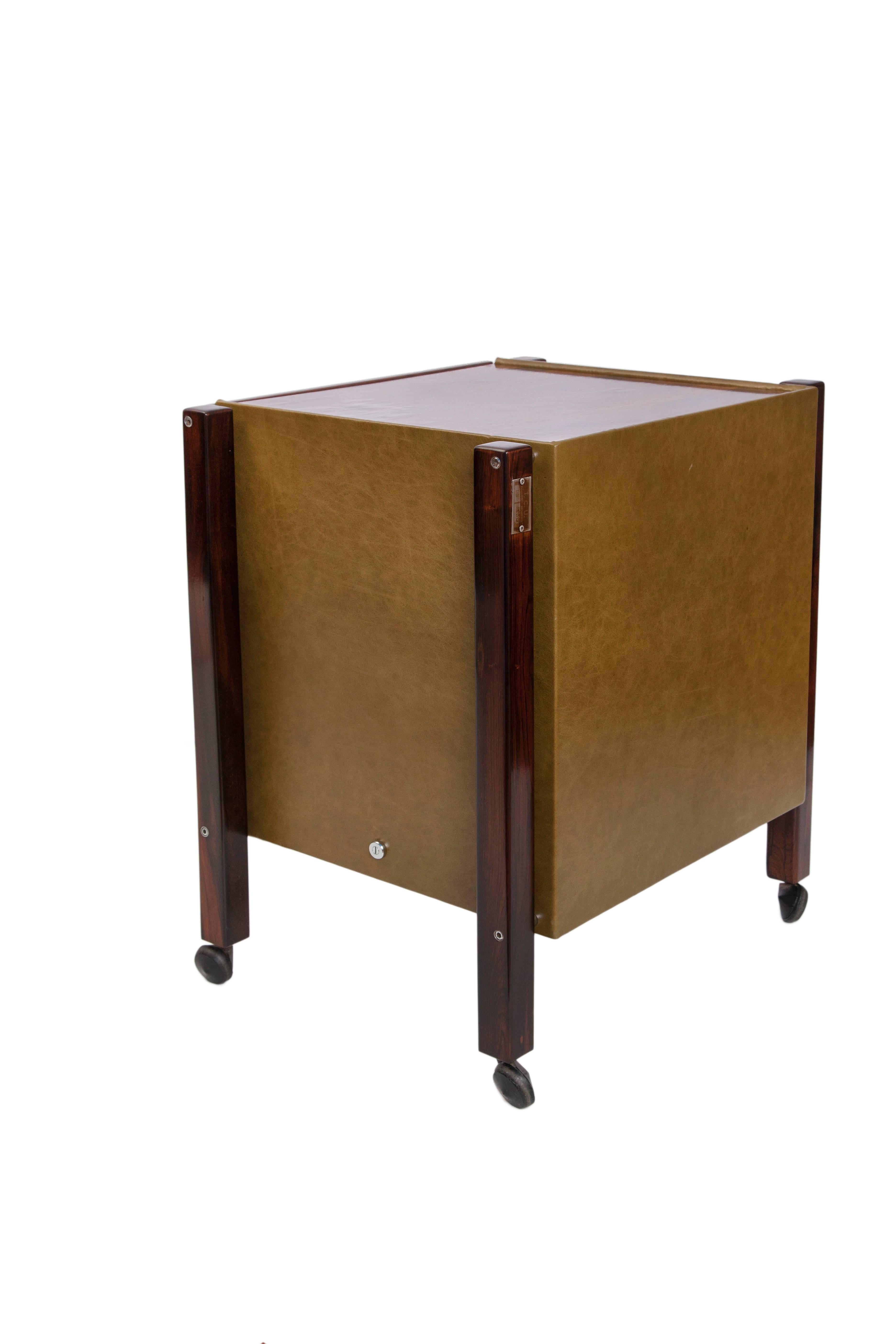 A pair of 1960s side tables on caster wheels by designer Jorge Zalszupin, each including patchwork top and legs in Brazilian jacaranda, single drawer with metal pull handle, green leather to the back and sides. Excellent vintage condition,
