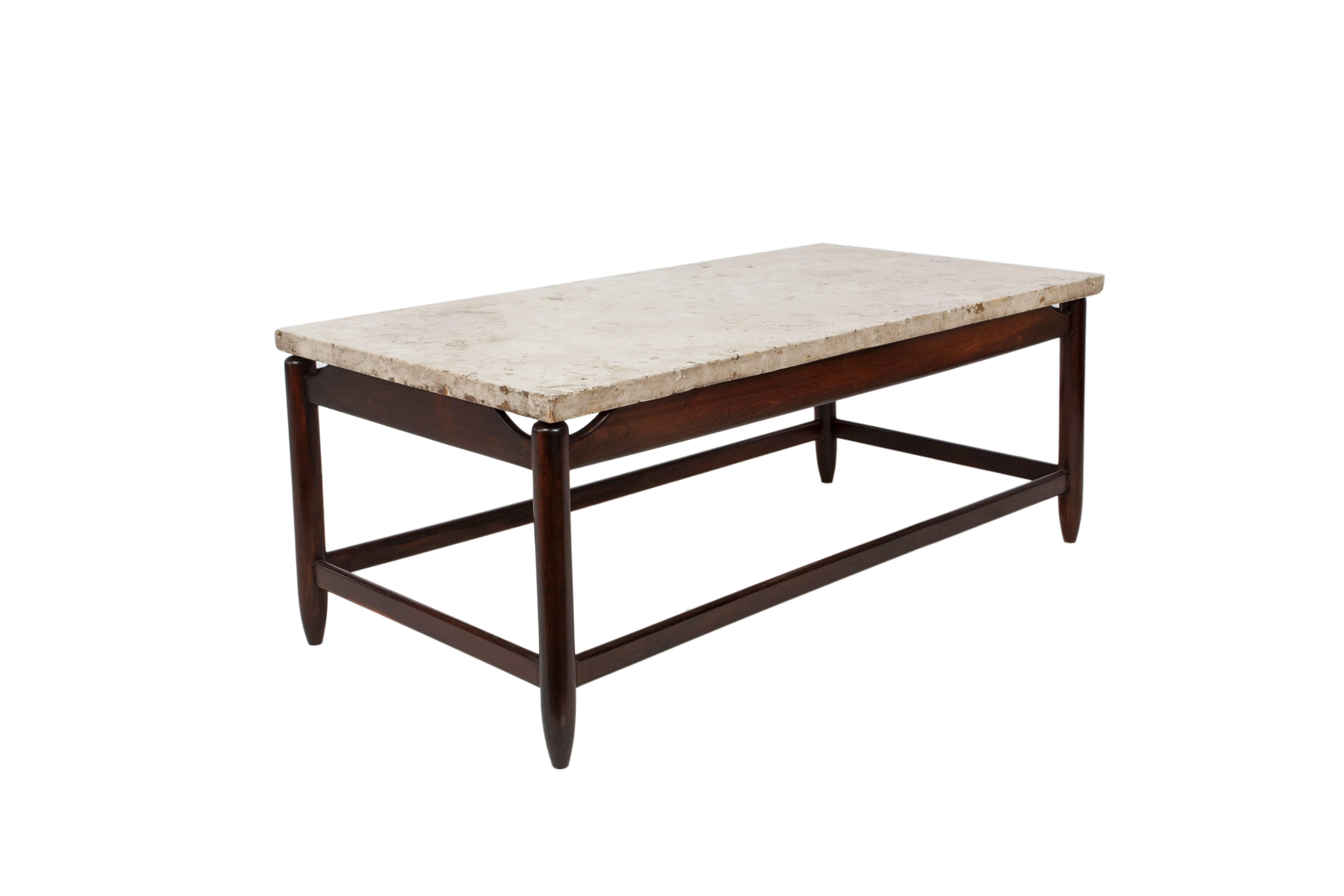 A Brazilian modern coffee table, produced, circa 1960s by Brazilian architect and designer Sergio Rodrigues, marble top on wood base, with stretcher poles and tapered legs. Excellent vintage condition, consistent with age and use.