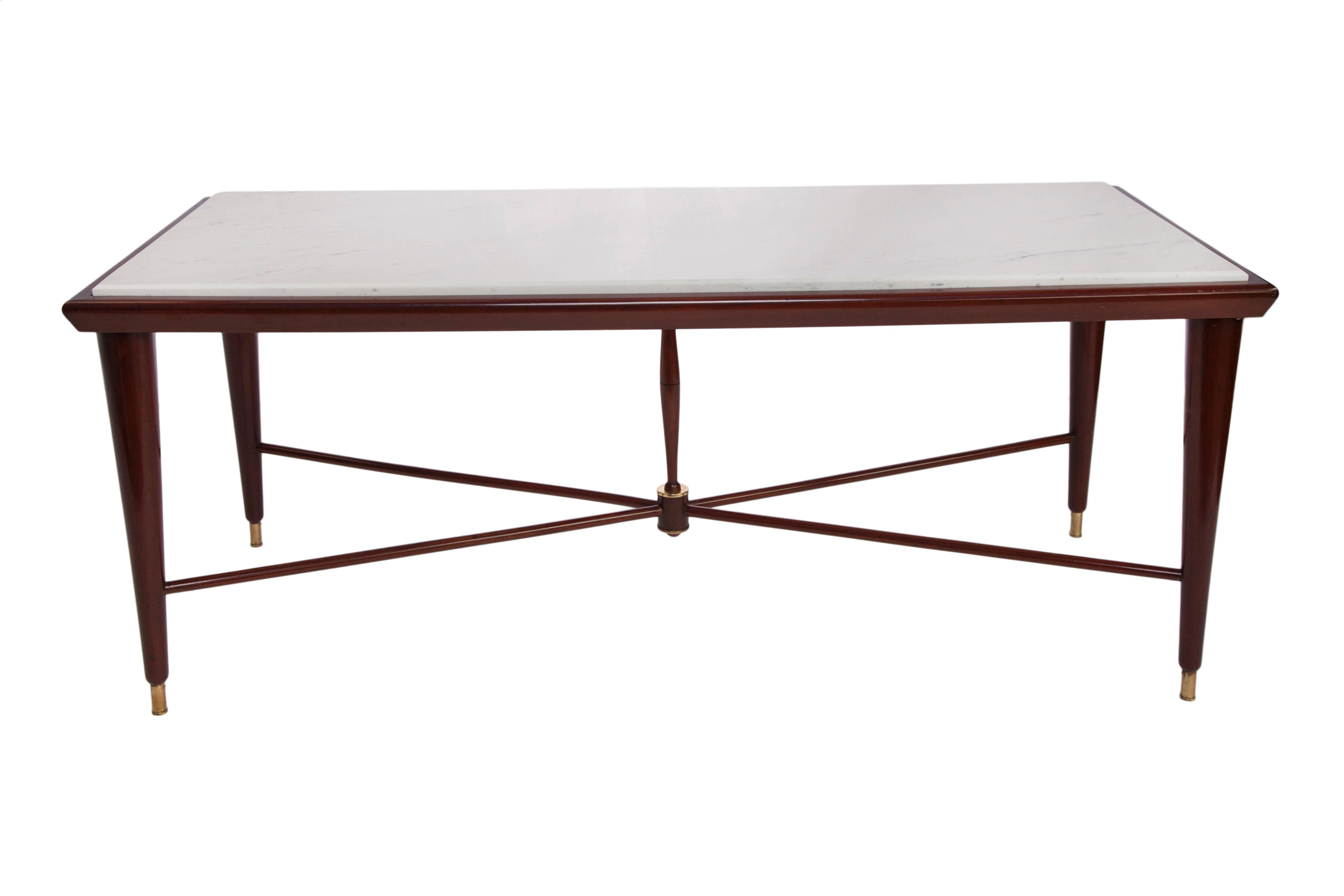 This Liceu de Artes e Ofícios 1960s coffee table, comes with a marble top on tapered legs, with crossed stretcher and central nucleus, accented with brass. The table remains in excellent vintage condition, consistent with age and use.