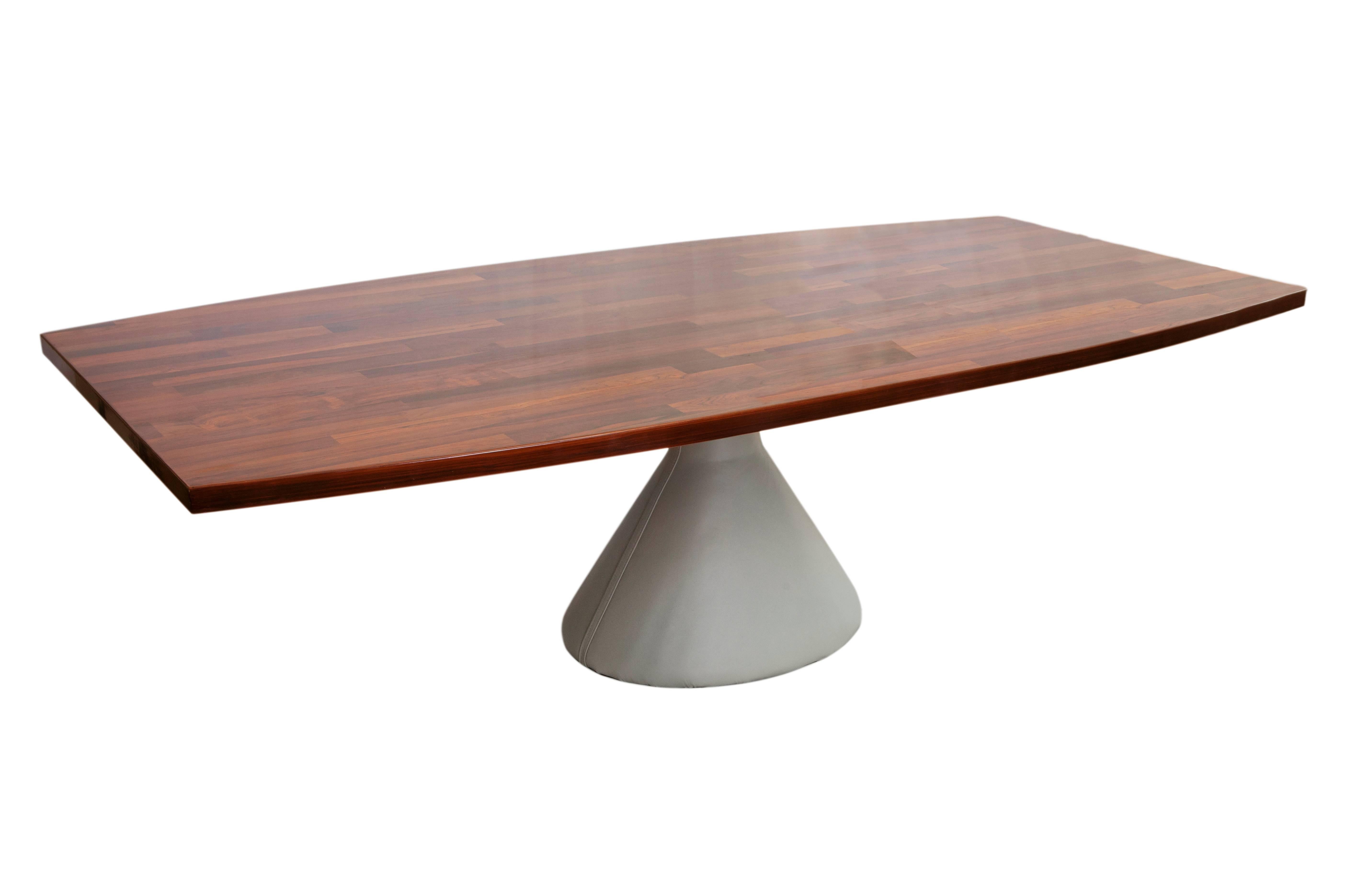 The 'Guaruja' dining table by architect and designer Jorge Zalszupin, including a  rounded top in Brazilian jacarandá and raised on conical pedestal base with gray leather cover. Excellent condition and leather base recently reupholstered.