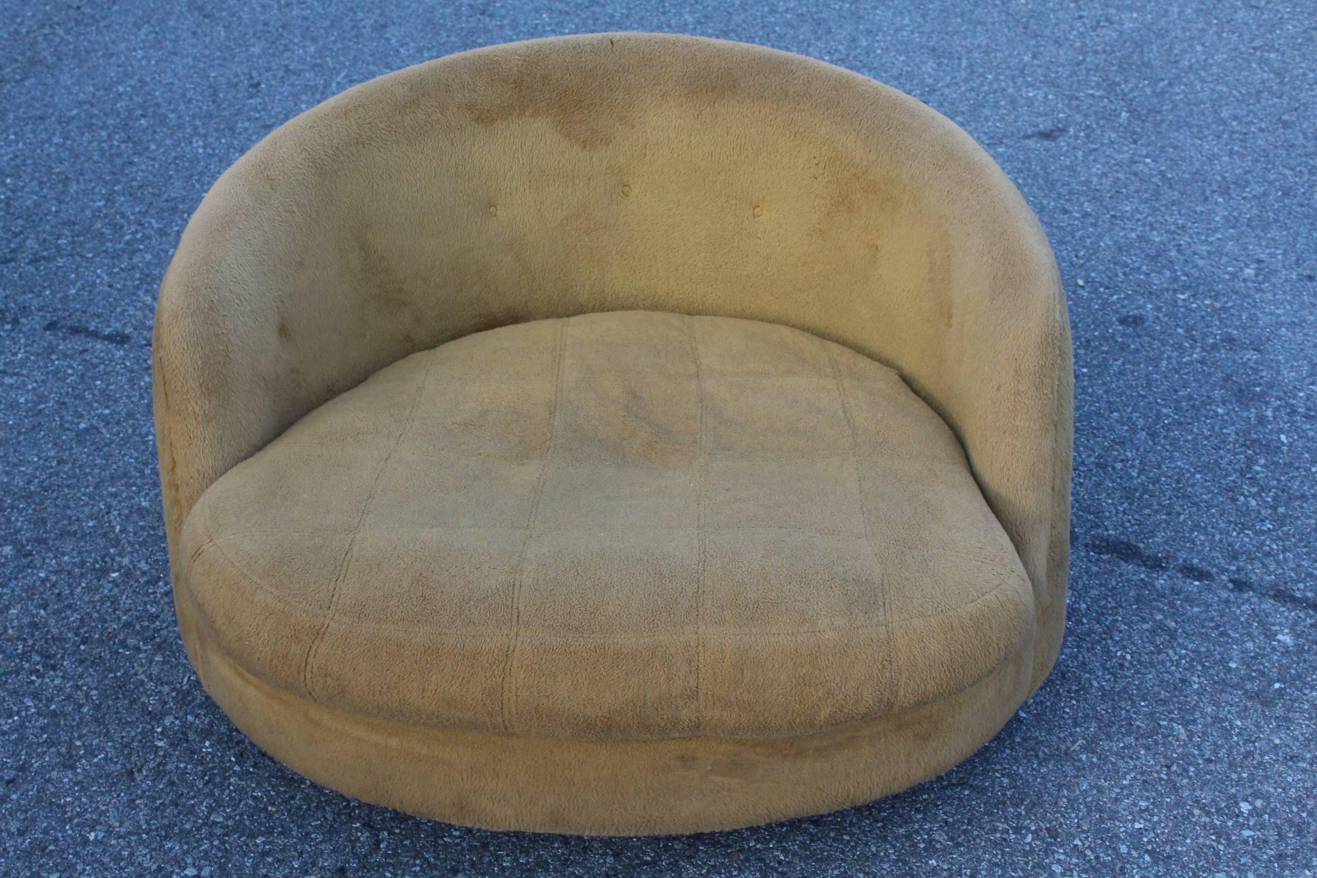 An over-sized vintage lounge chair, designed by Milo Baughman for Thayer Coggin, with round tufted back on plush seat; fixed base does not swivel. Markings include Thayer Coggin manufacturer's label. The chair remains in overall good vintage