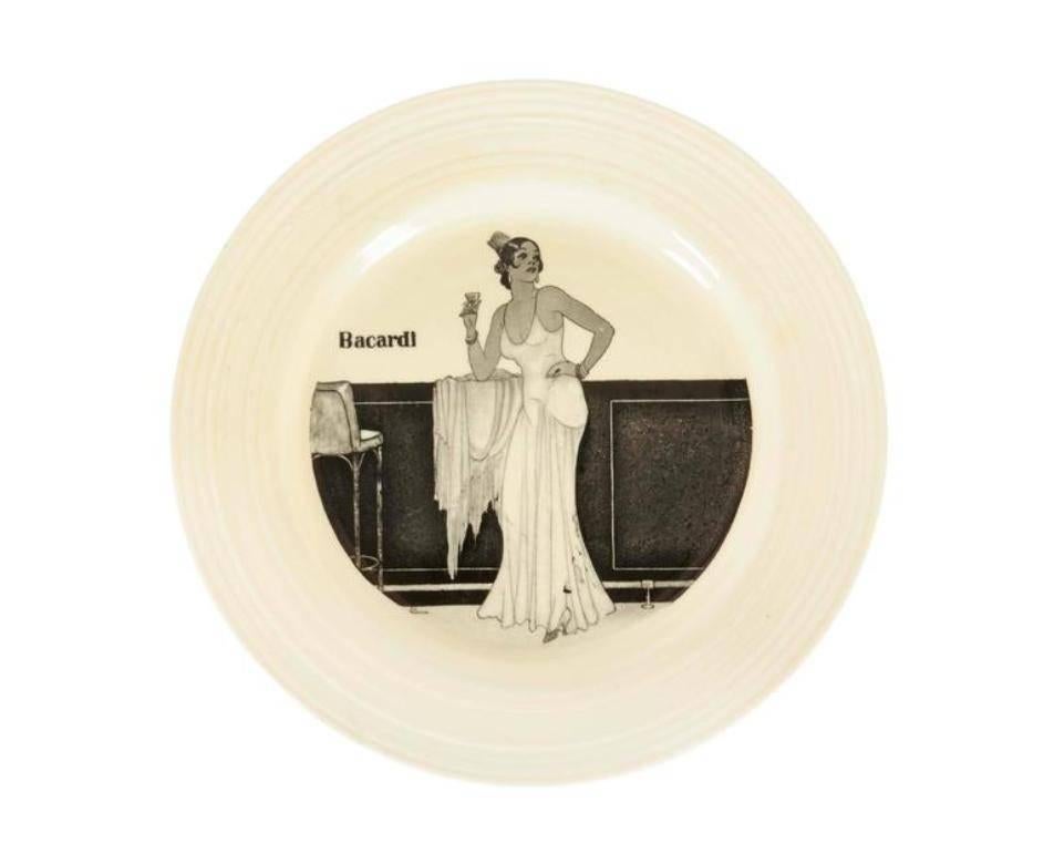 An arrangement of four Art Deco era porcelain plates by Crown Ducal of England, produced circa 1930s-1940s, each depicting a lady with a cocktail, standing alongside a bar, illustrated by C.W. Anderson. The figures are specifically styled to embody