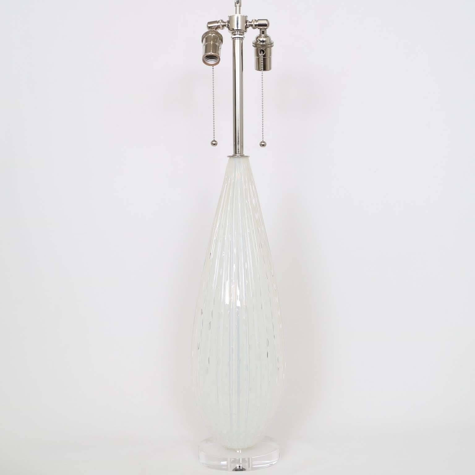 Murano glass lamp with controlled bubbles by Barbini, mounted on a Lucite base. The noted height is to the finial. The height to the top of the glass body is 22.5″. Fully restored with all new wiring and hardware, including a double socket cluster.