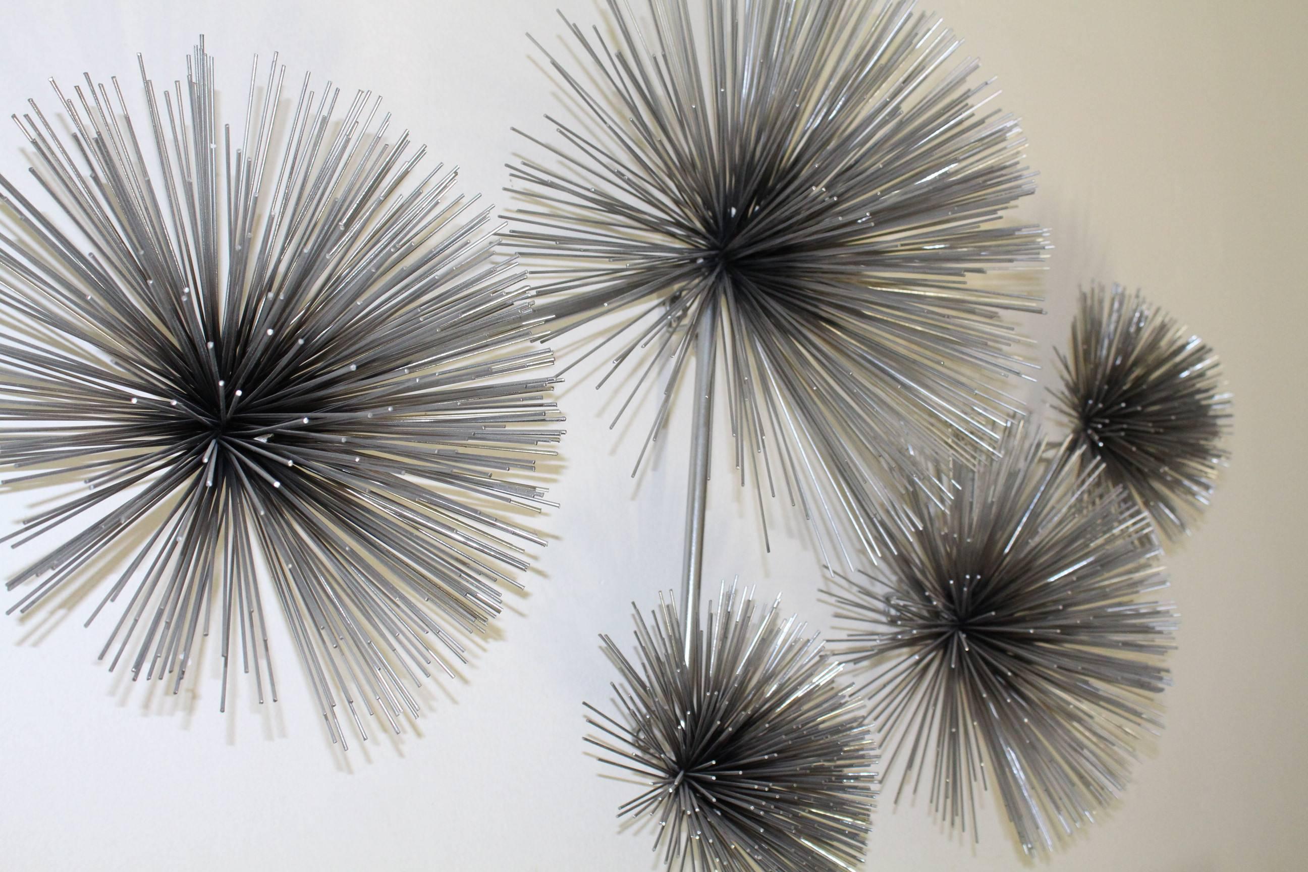 A contemporary Brutalist style wall-mount sculpture by Curtis Jere, after the original 1970s 'Oursin' (Urchin) installation, comprised of five pom poms with extending spires in various sizes. Markings include signature and date (slightly