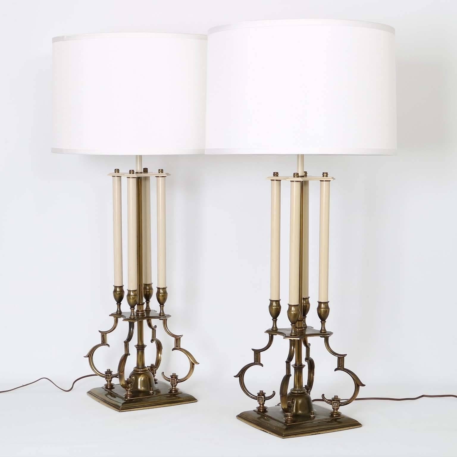 Mid-Century Modern pair of lamps in brass by designer Tommi Parzinger for Stiffel, bases influenced by Gothic styles. Very good vintage condition, wear is consistent with age and use. The noted height is to the top of the finial. 

Please note