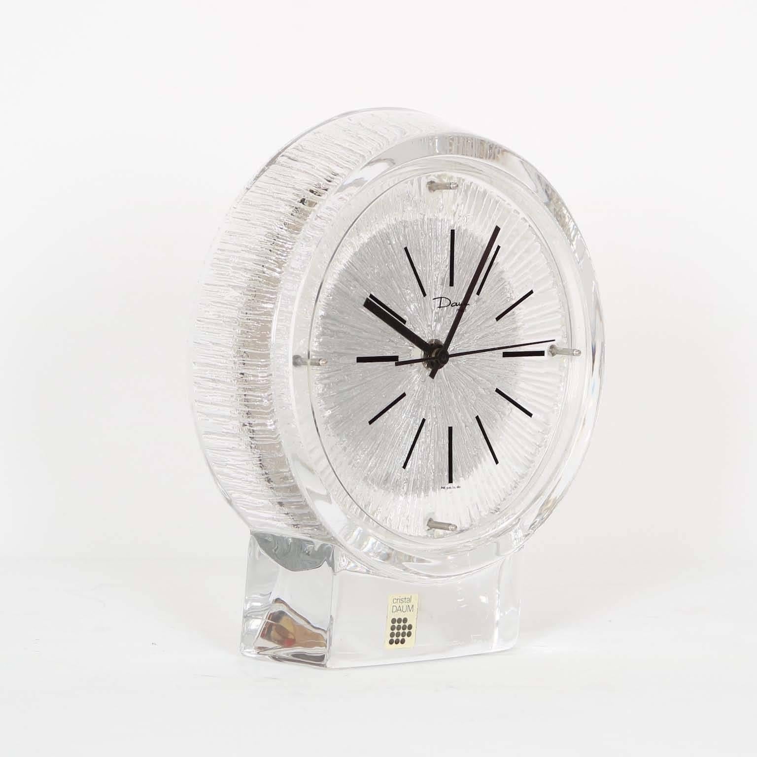 A Thor model desk clock by Daum, produced in France, circa 1970s, round glass face set against textured crystal on clear base. Markings include original label [Crystal Daum] to the front along the base. Excellent vintage condition, consistent with