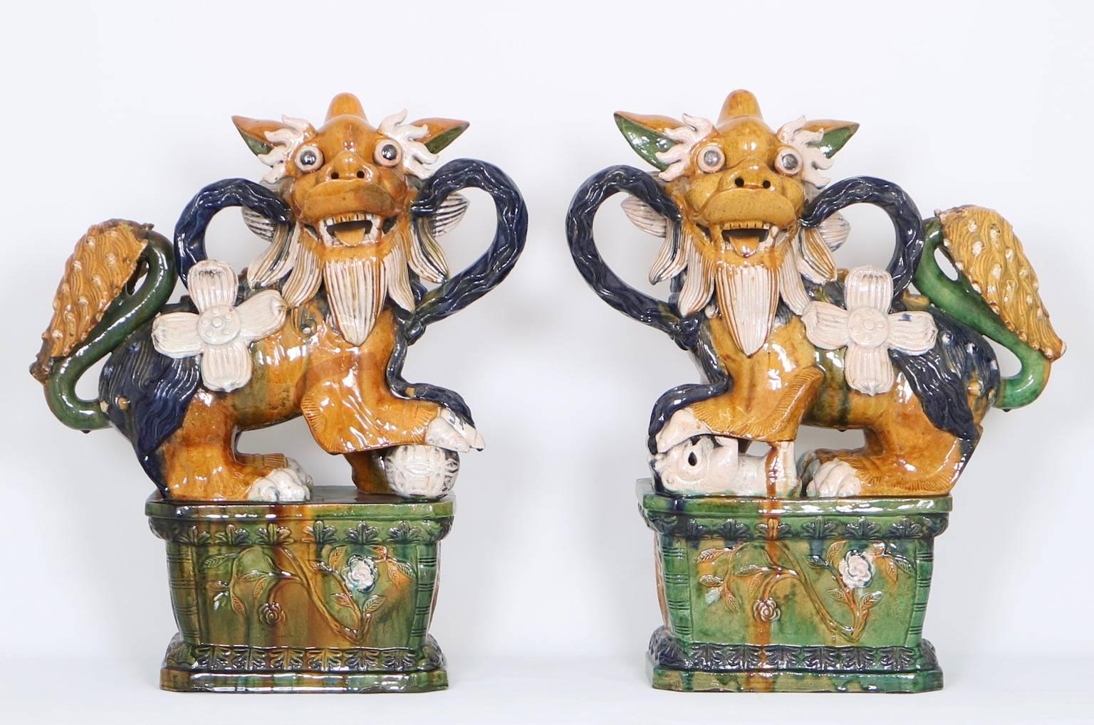 A pair of large Chinese foo dogs, produced within the early 20th century period, each in colorfully glazed in Majolica. Excellent vintage condition, any presence of wear consistent with age and use.

11032