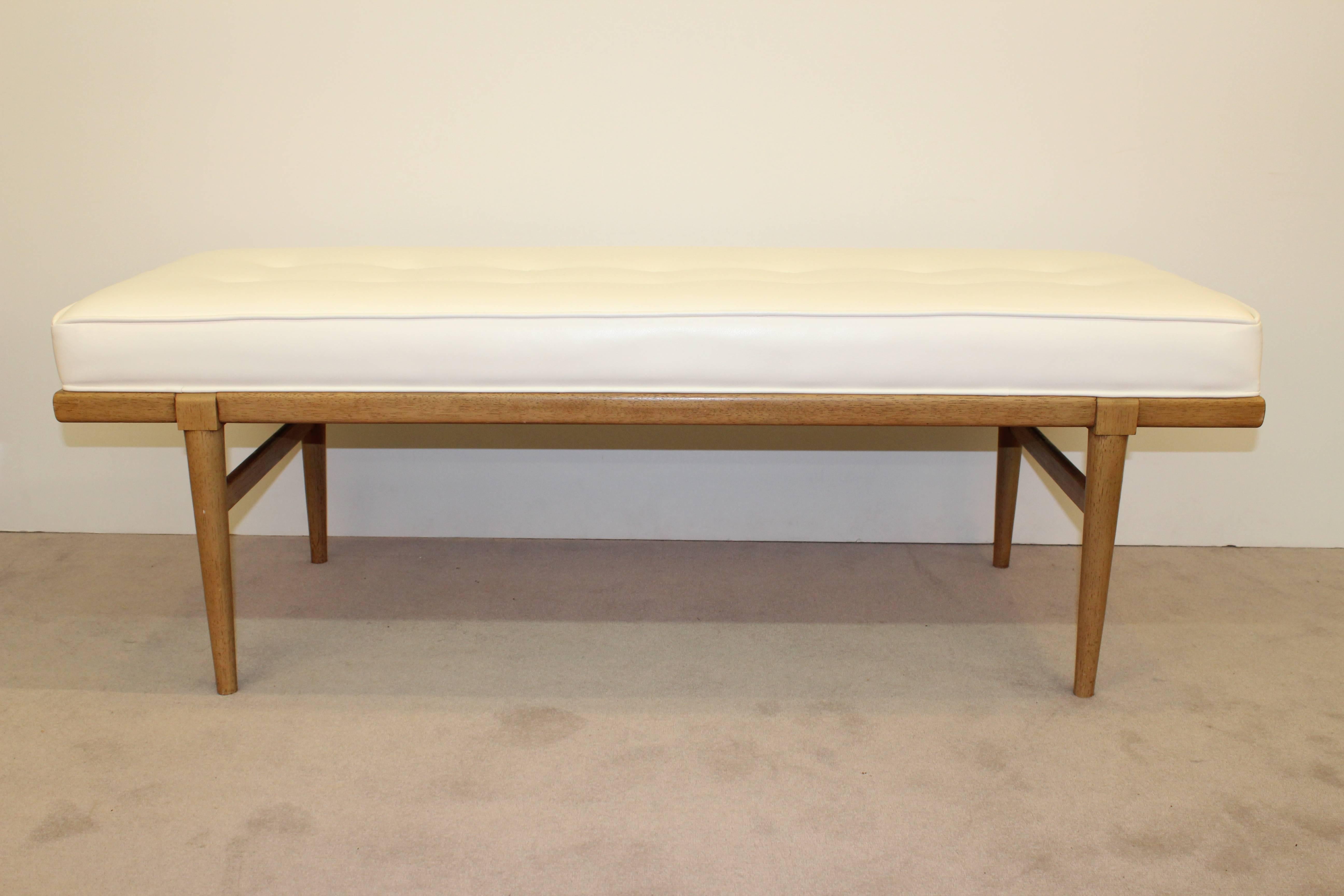 A mahogany bench by Robsjohn-Gibbings. Newly re-upholstered in white leatherette. In very good condition consistent with age and use.

110084
