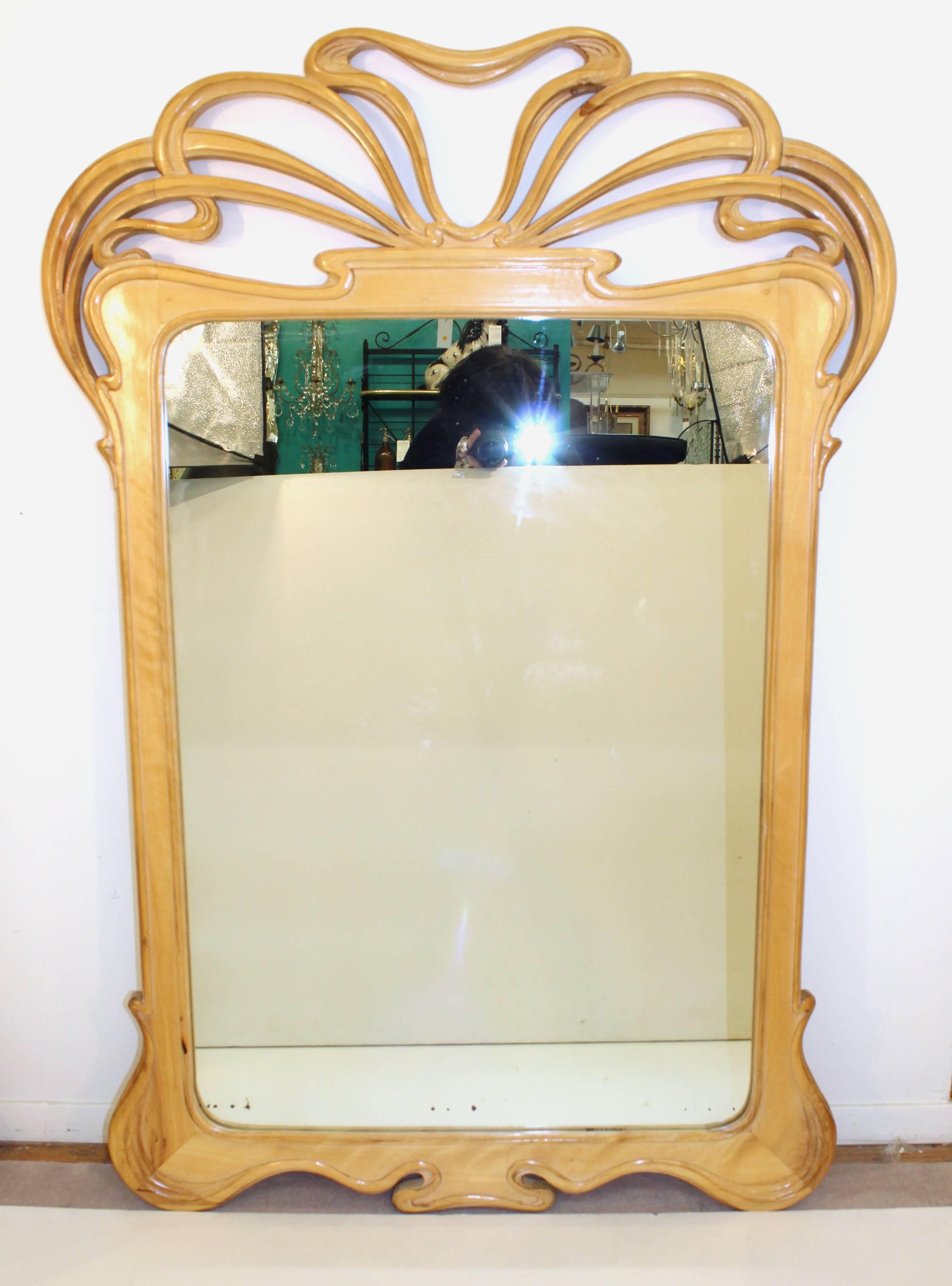 A pair of large mirrors with carved wooden frames from the mid-20th century in the Art Nouveau style. These mirrors are in excellent condition.

110169
 