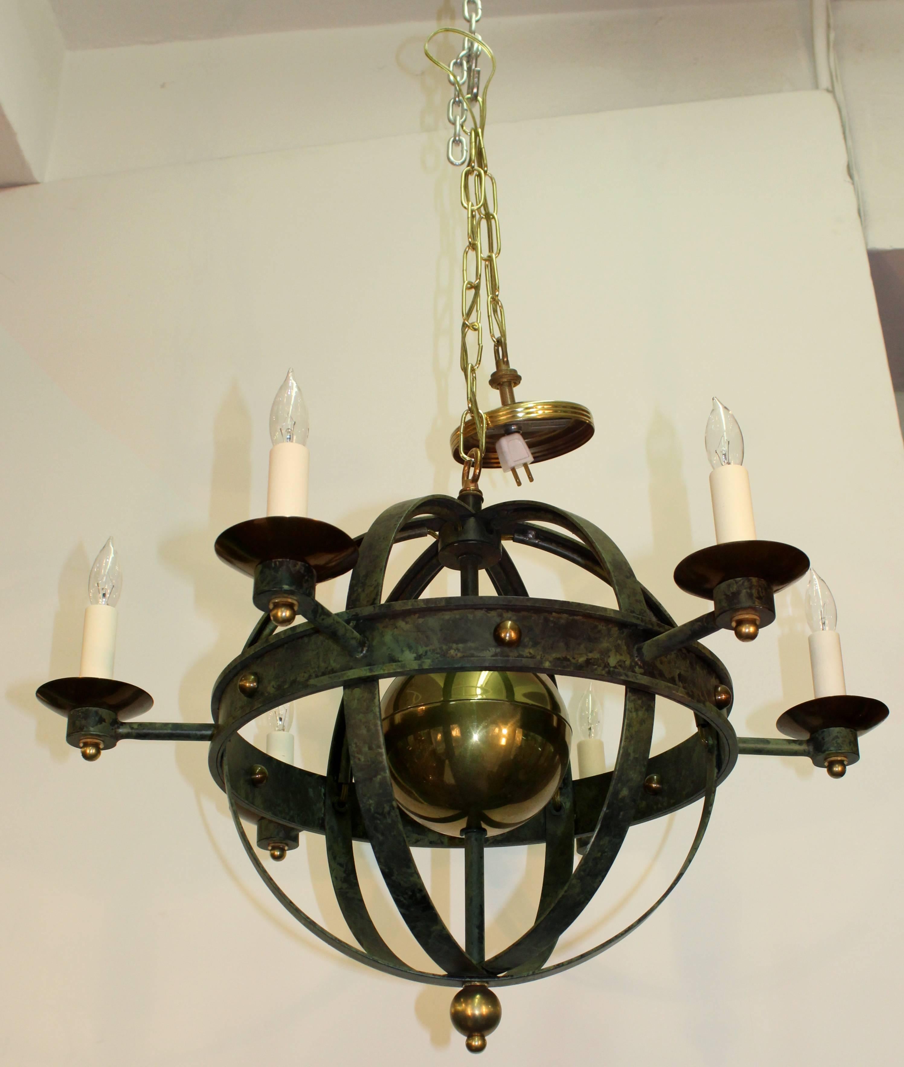 This Mid-Century orbit chandelier dates from the 1960s. Features brass trim and verdigris finish. This chandelier is newly rewired and takes six candelabra base bulbs. Chandelier is in very good condition, with age appropriate wear.

110173