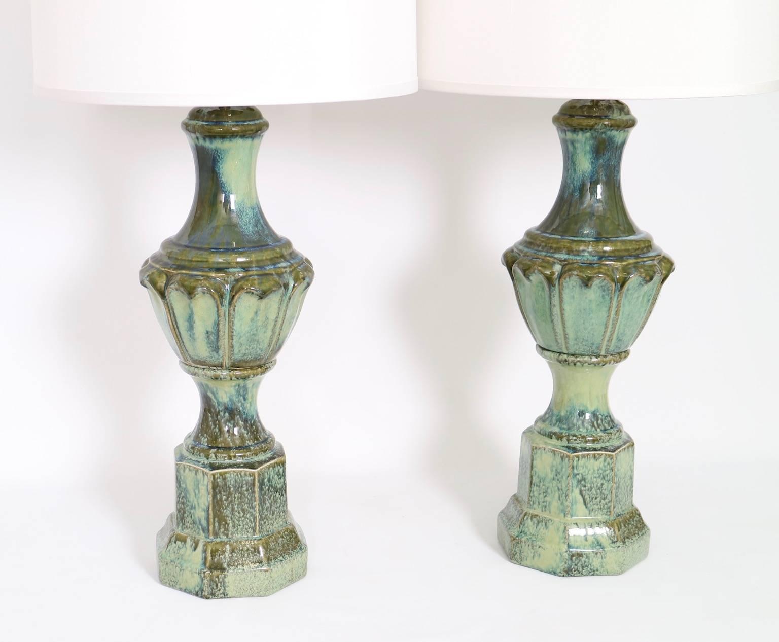 Pair of Mid-Century era American Hollywood Regency table lamps, produced circa 1950s, of classical baluster form in aqua-green glazed Majolica style porcelain. The noted height is to the finial, the height to the top of the body is 23.5 in (60 cm).