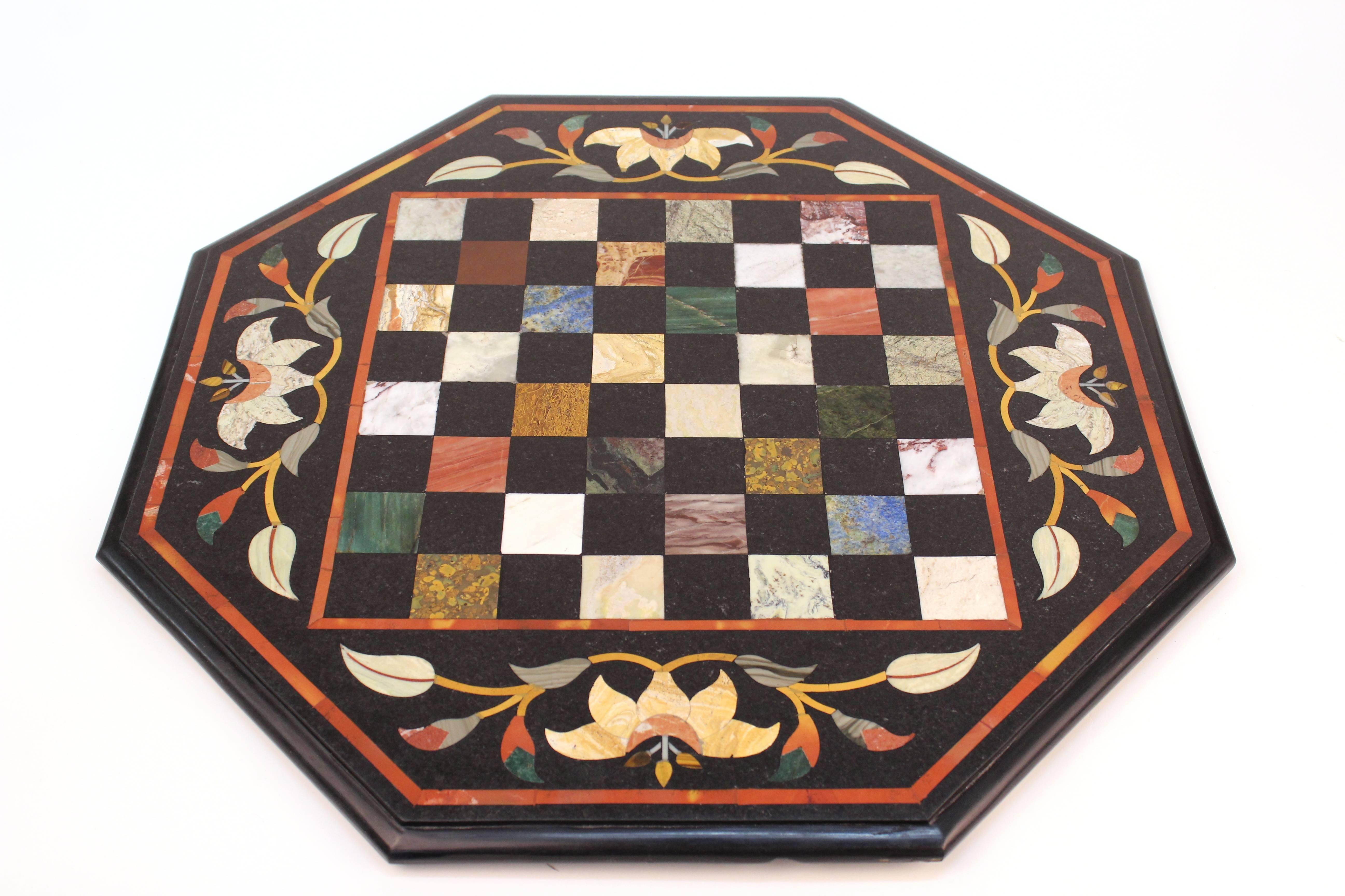  A chess board crafted using the Pietra Dura technique out of malachite, lapis, onyx and marble. Includes 32 bone and wood chess pieces. Produced in Italy during the 1960s. 

110485