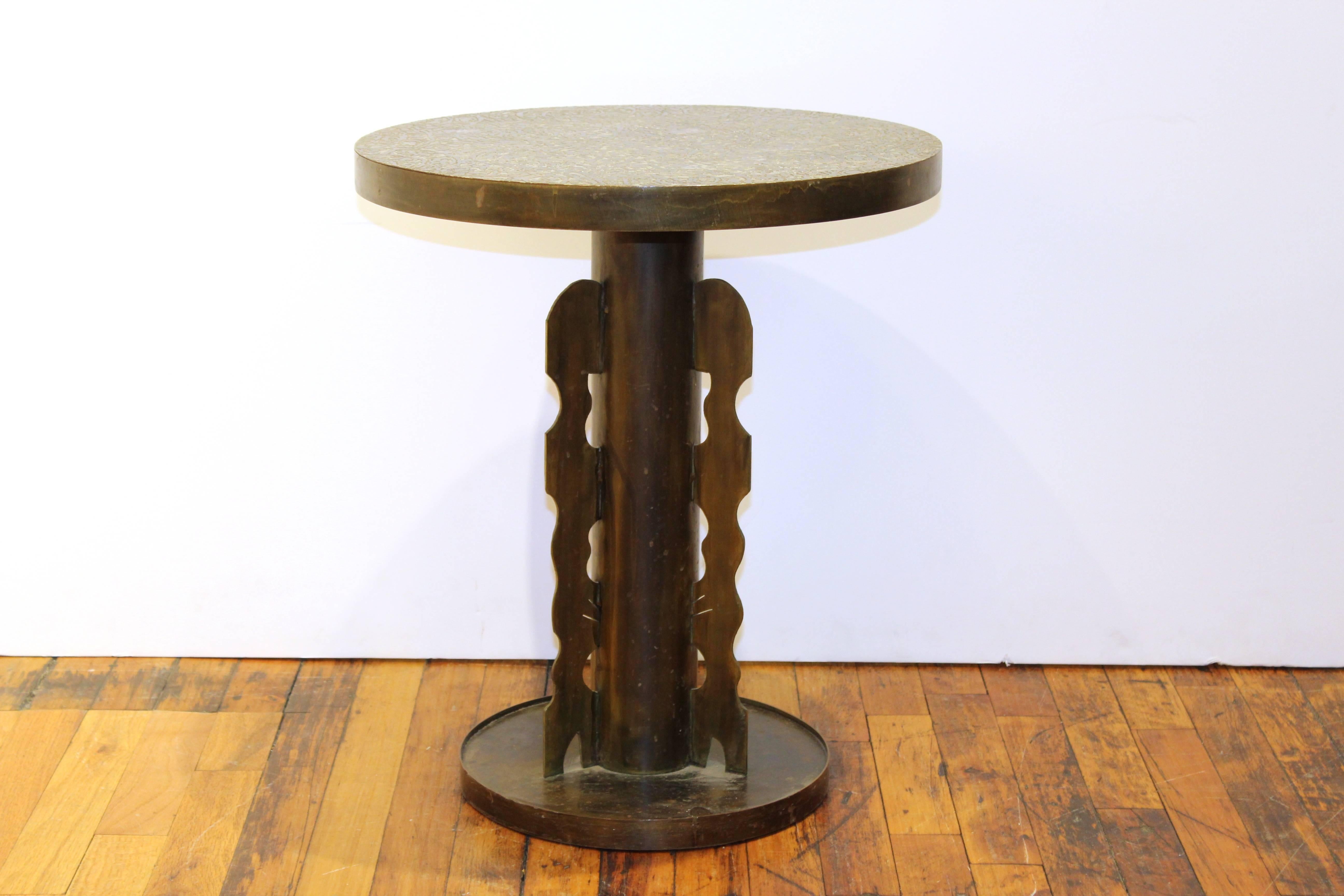 A unique side table designed by Erwine and Estelle Laverine with etched brass Etruscan pattern and column-like base.

110376.