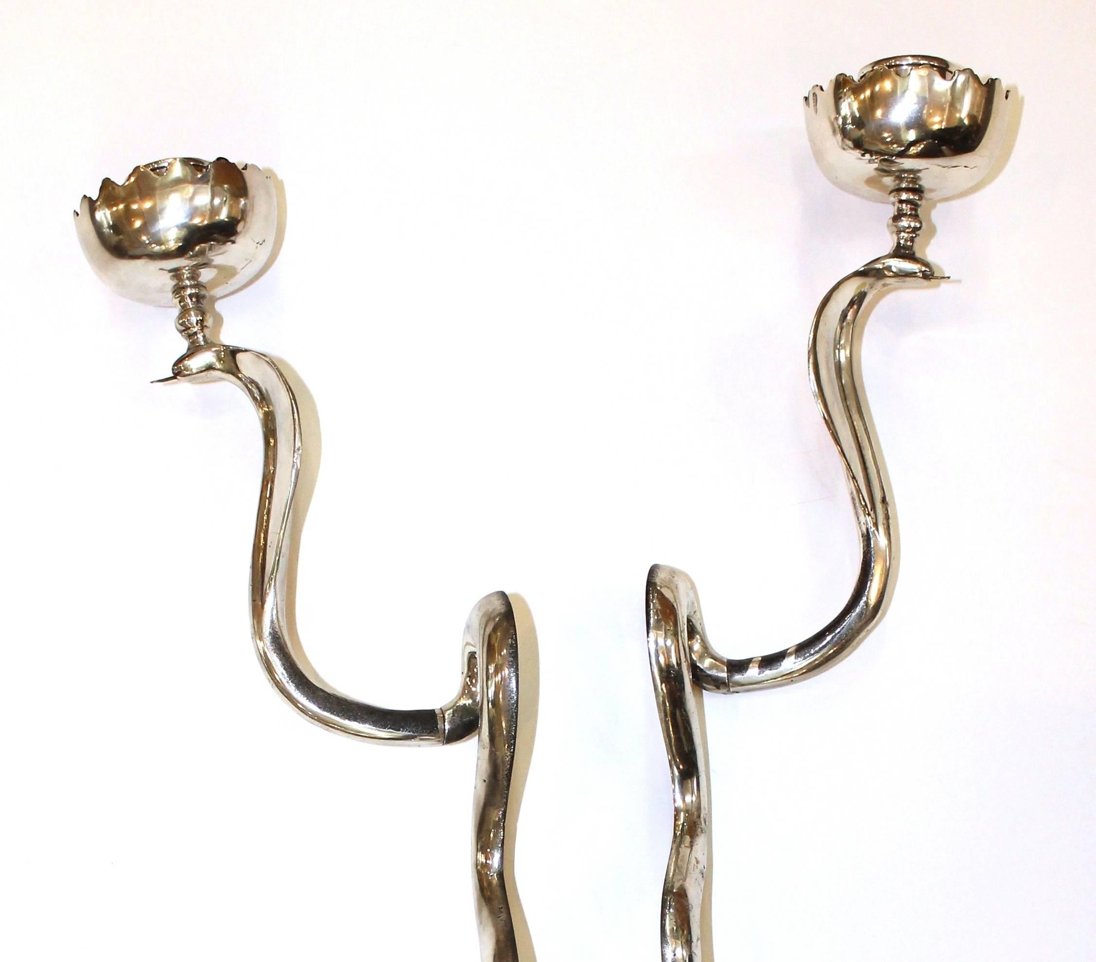 Pair of mid-20th century sculptural candle sconces as serpentine cobras, with metallic finish, each surmounted by lotus bobeche. Very good condition, wear to finish consistent with age and use.

110383