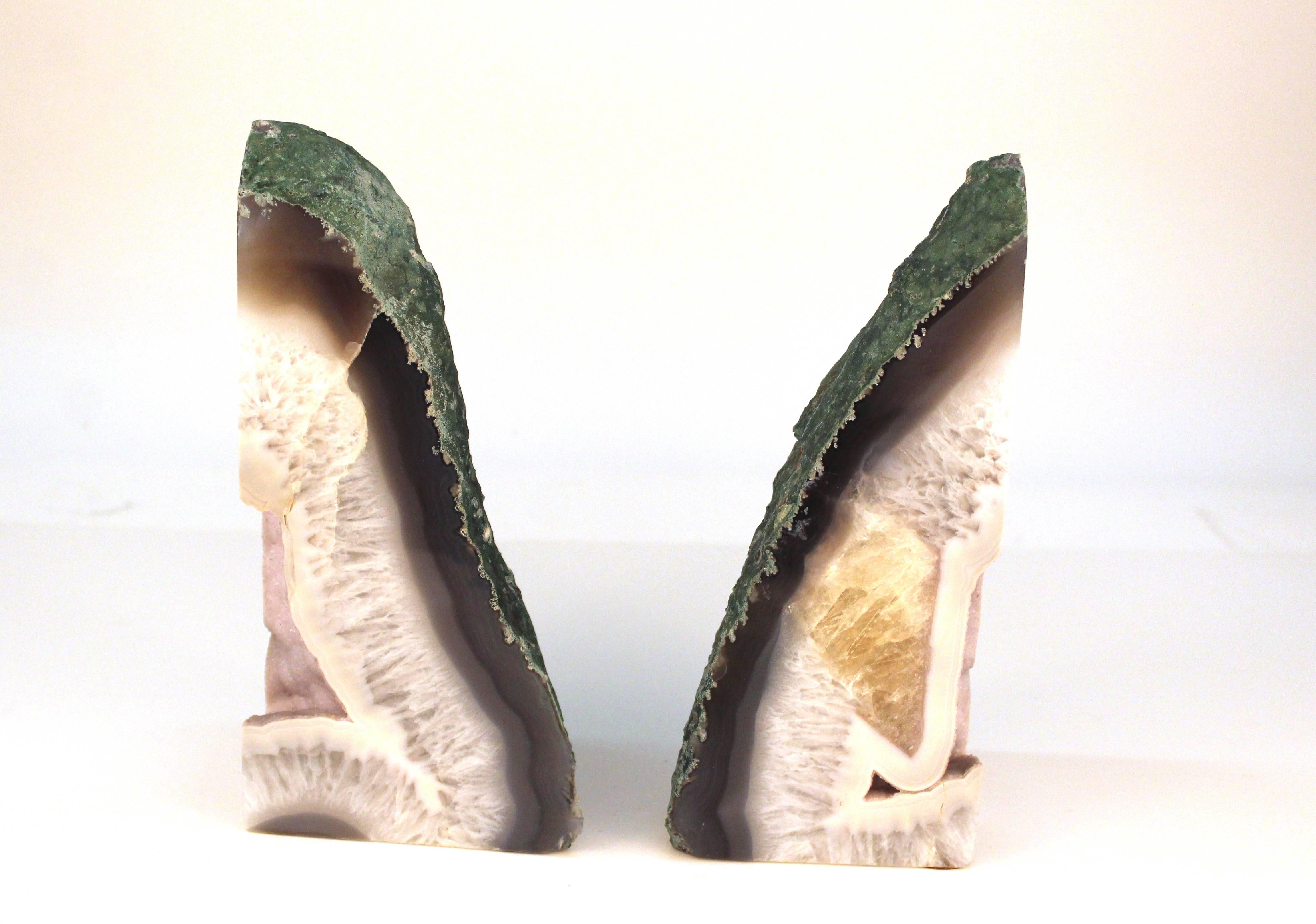 Agate bookends, large in size and sliced down the center. Smooth crystallized interior in pale purple hues with a rough textured exterior.

110586

             